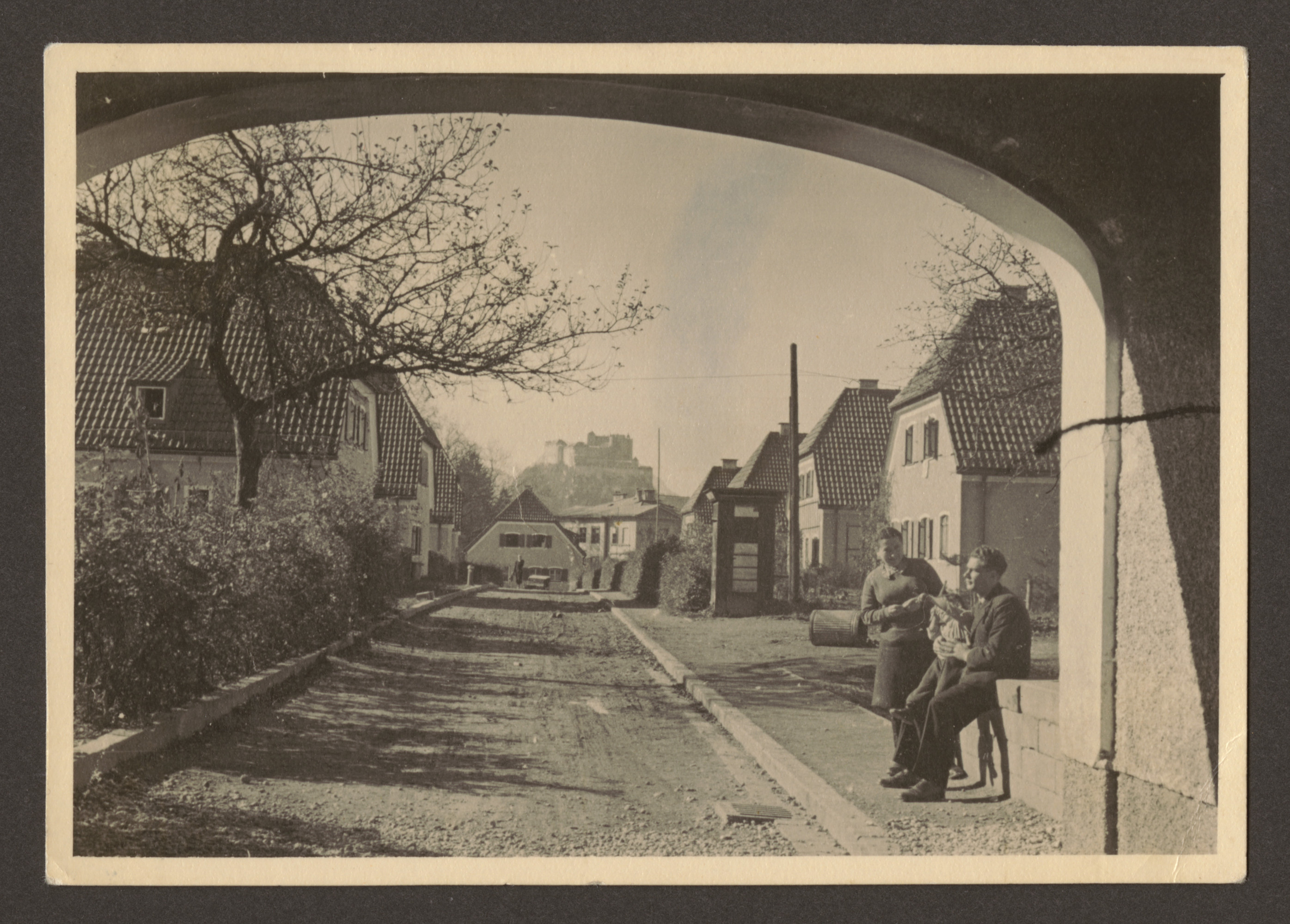 Manya Blacher and an unidentified man pose under an archway in Salzburg [perhaps on their way to Germany].