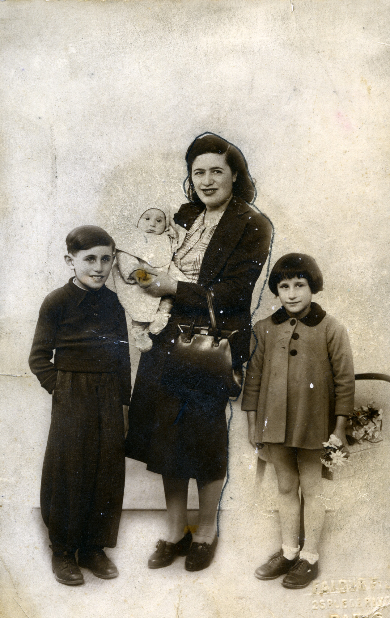 Photograph of a French Jewish family, taken to send to the father while he was imprisoned in Pithiviers. 

Pictured are Claire Flantzer and her children (left to right): Gilbert, Pierre, and Solange.  The photograph was to send to Leon Flantzer.