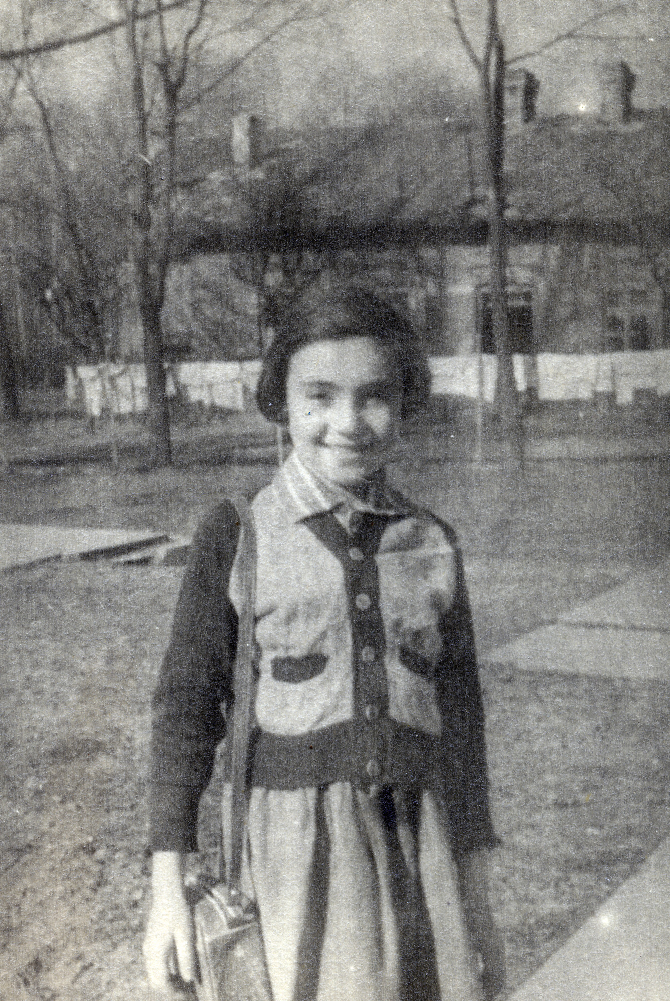 Leah Alterman stands outside an orphanage in Warsaw shortly after the end of the war.