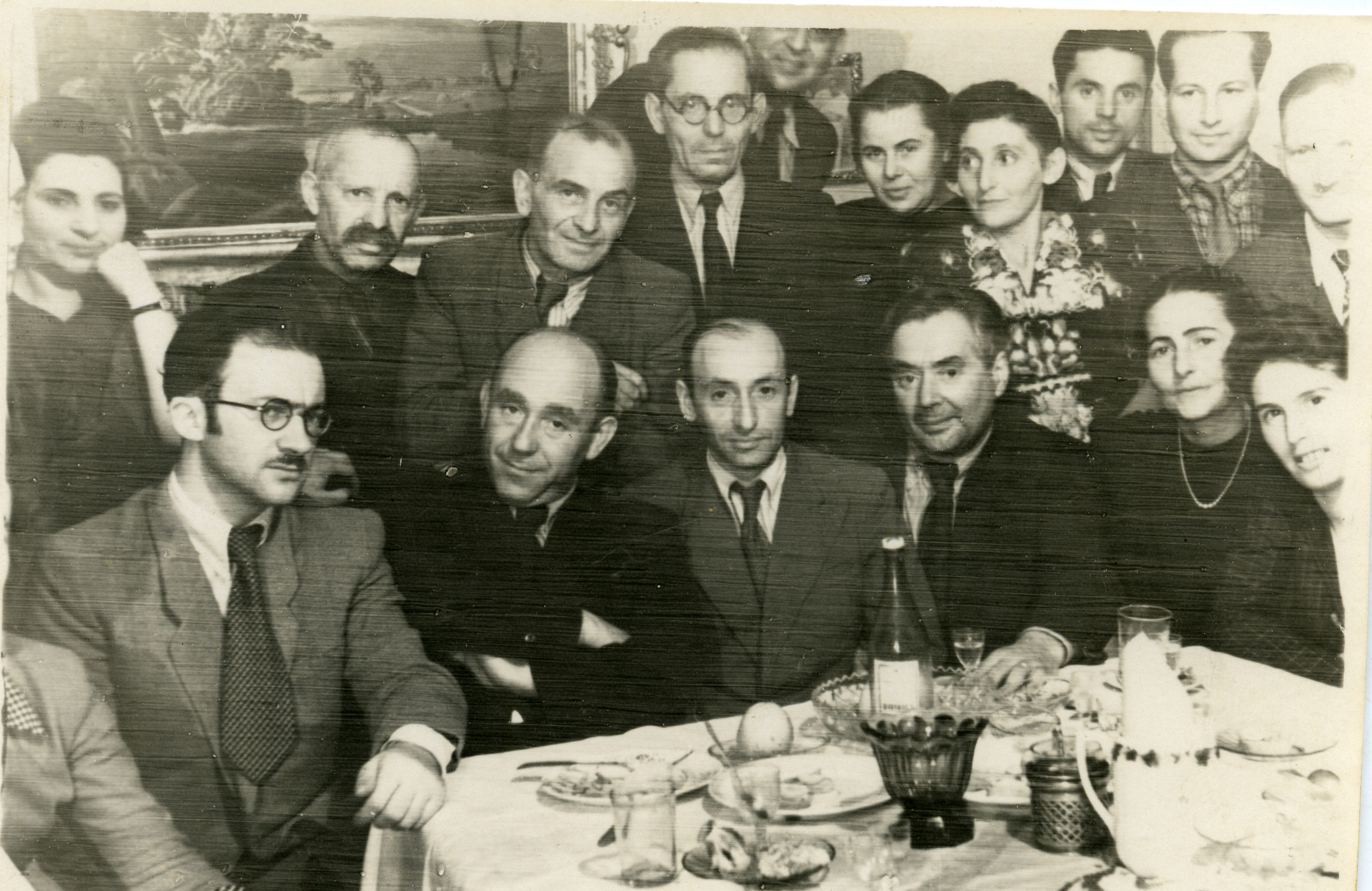 Farewell party for Leyzer Ran, a prominent postwar chronicler of Jewish life in Vilna.  

From Vilna, he and his wife Basheva traveled first to Paris and then, denied entry to the United States, to Cuba. 

Among those pictured are Leyzer Ran (front, center),  his wife Basheva (Konski) Ran (front row, far right),  Avraham Sutzkever, (front, left) and his wife Freydke (back, far left).