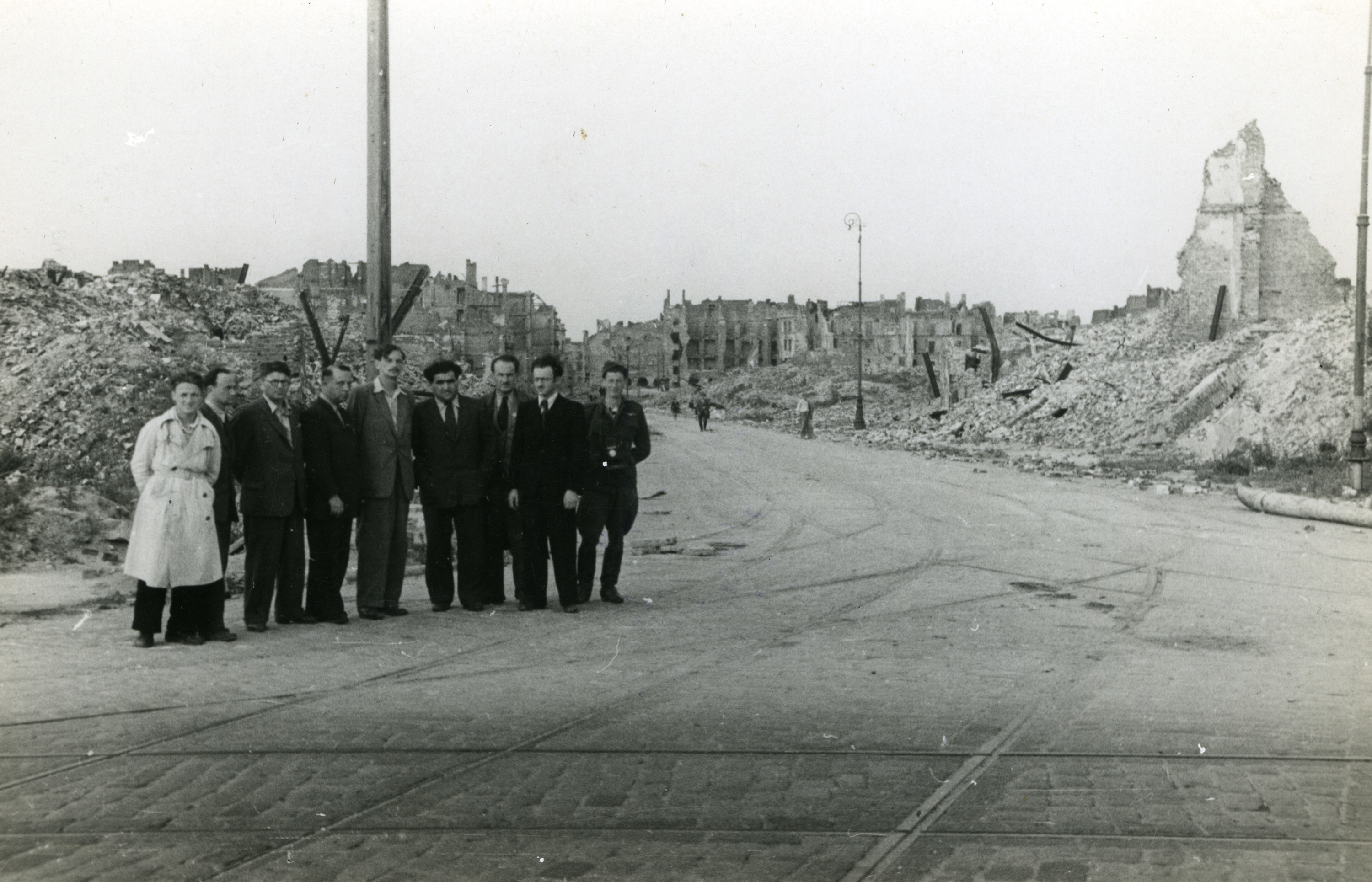 Group portrait of Polish Jewish intellectual and cultural leaders standing amidst the ruins (possibly in the Warsaw ghetto).

Among those pictured are Professor Avram Novershtern (fourth from the left) and Yitzkah (Antek) Zuckerman (fifth from the left).   Novershtern survived the war and became a prominent Israeli Yiddish scholar.