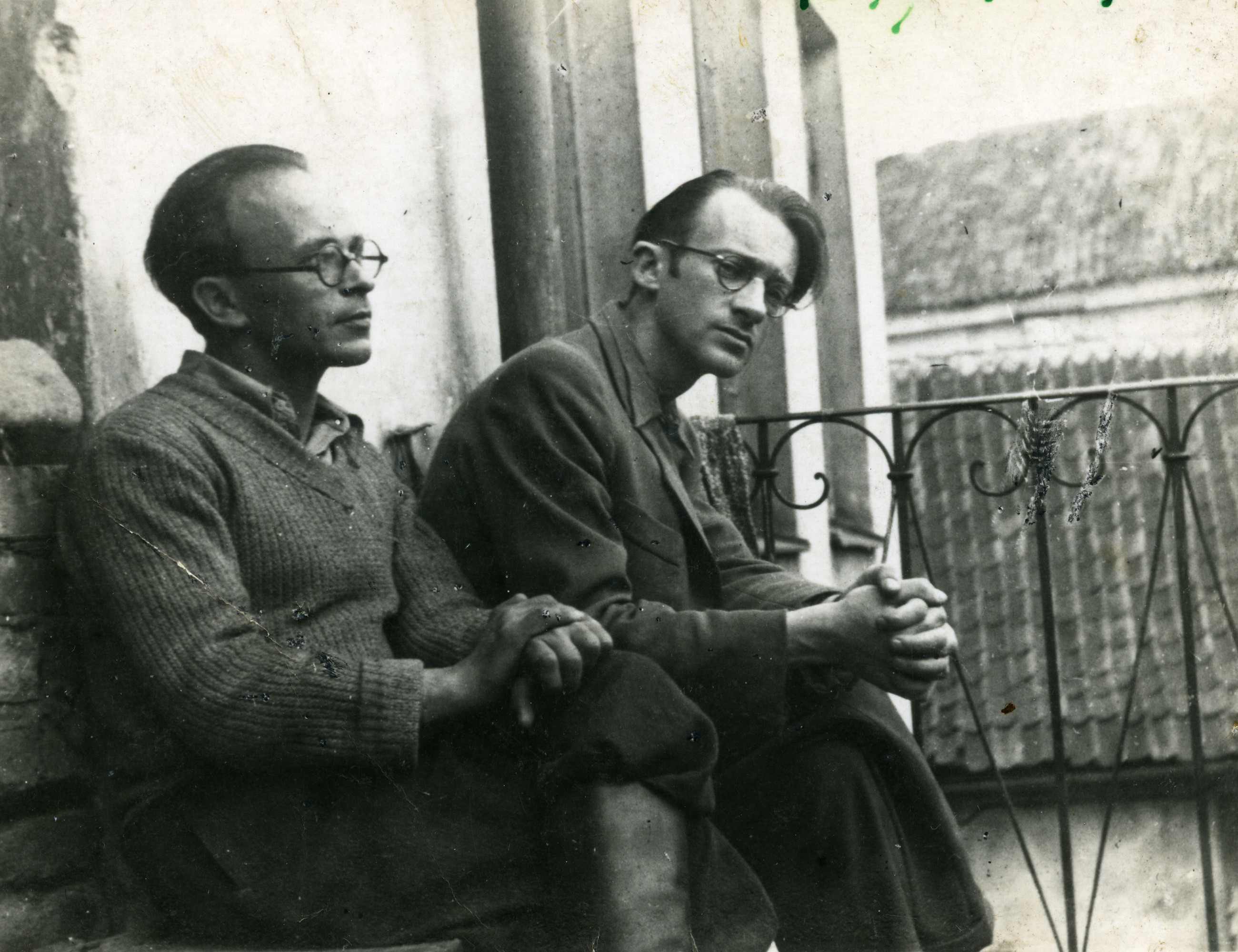 Avraham Sutzkever (right) and his friend Shmerke Kaczerginski sit on a terrace within the Vilna ghetto.