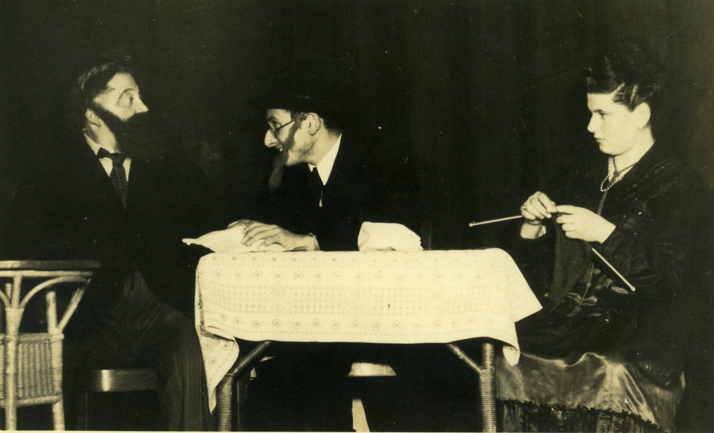 Three actors perform in a play at a displaced persons camp in Davos, Switzerland.  

Pictured on the right is Minna Kuperberg.