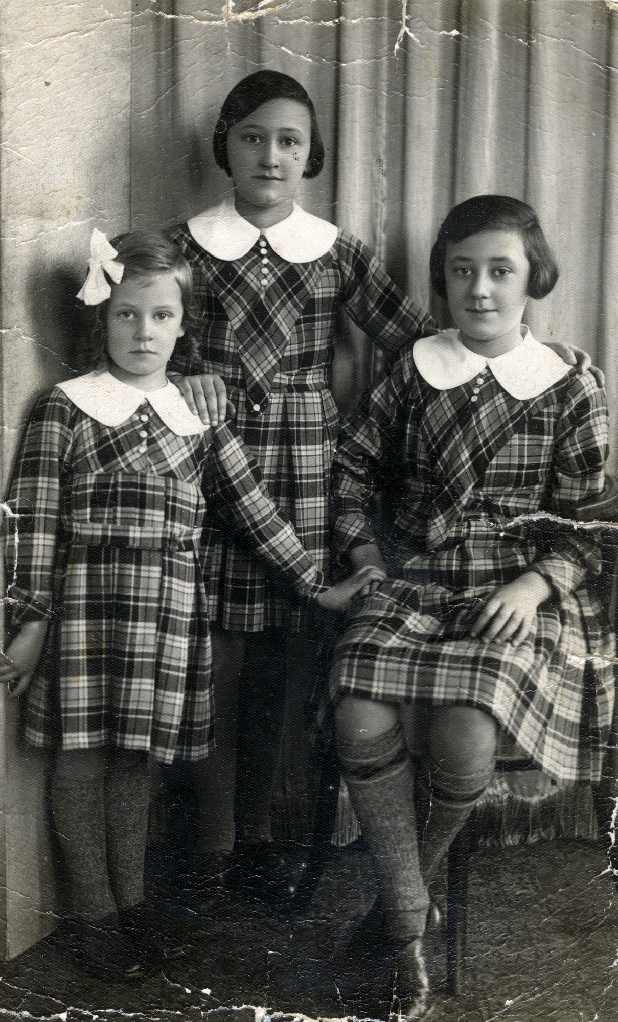 Belgian Jewish sisters wearing matching dresses pose for a photograph before Pesach (Passover).

Pictured from left to right are Naomi, Eva, and Rachell Isboutsky.