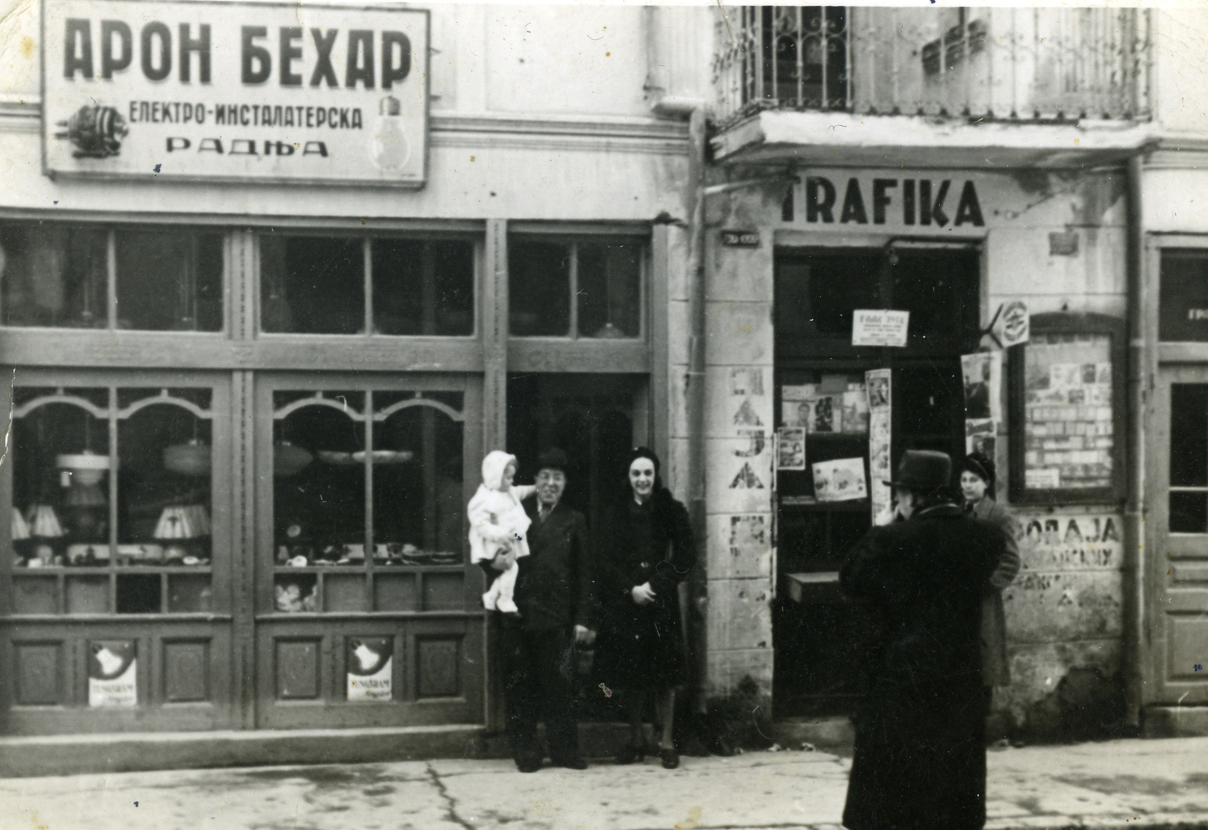 A Jewish couple with their baby daughter, in front of their electrical goods store.

Pictured are Aharon and Rebeka Behar, with baby Bienonida.