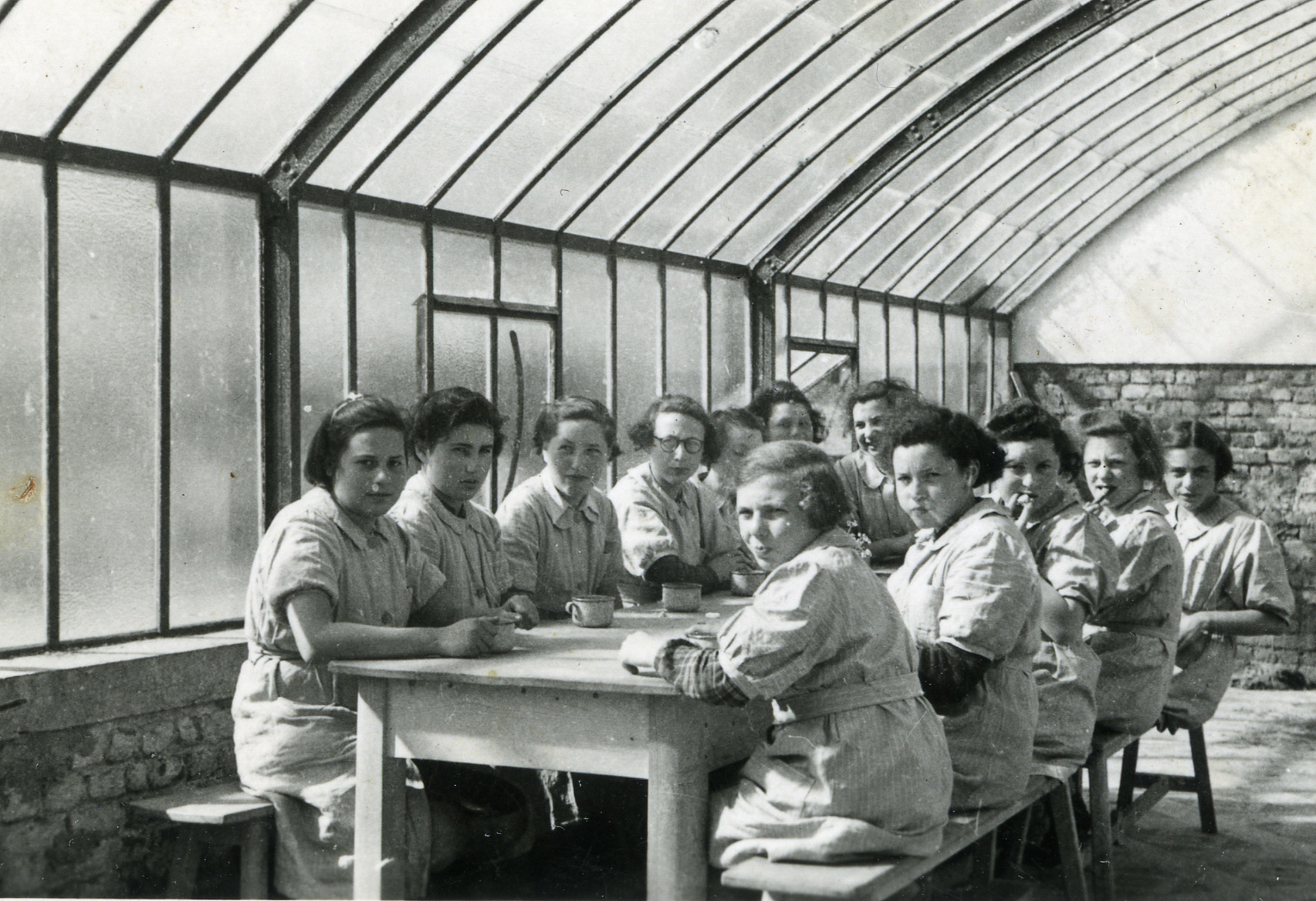 A group of girls gathers for a meal in the dining hall of a children's home in Aische en Refail.

The dining hall had been converted from a former greenhouse.