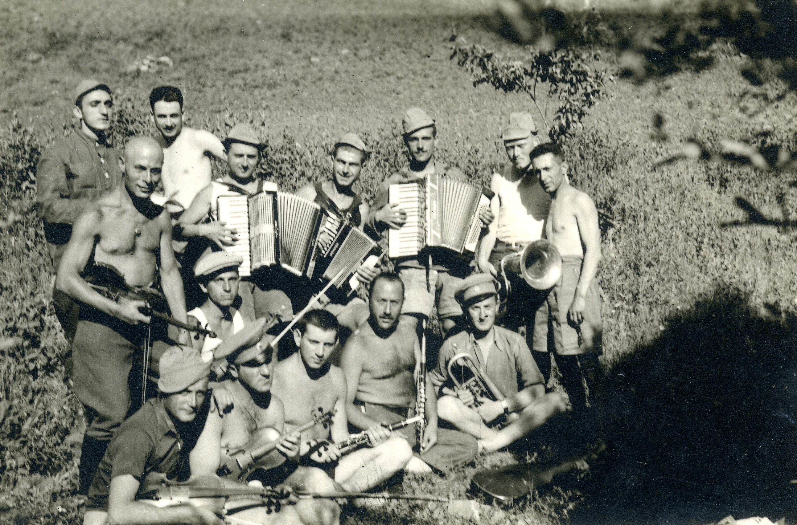 Group portrait of Bulgarian musicians in an unidentified location, possibly in a labor camp.

Among those pictured is Nissim Alkalay (seated in front, second from the left).