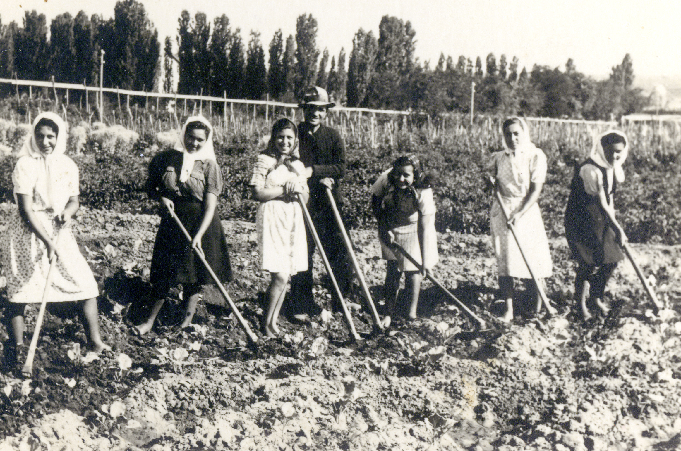 Jews from Sofia tend their garden outside Haskovo, Bulgaria, where they had been deported.

Among those pictured is Lore Beracha (far left).