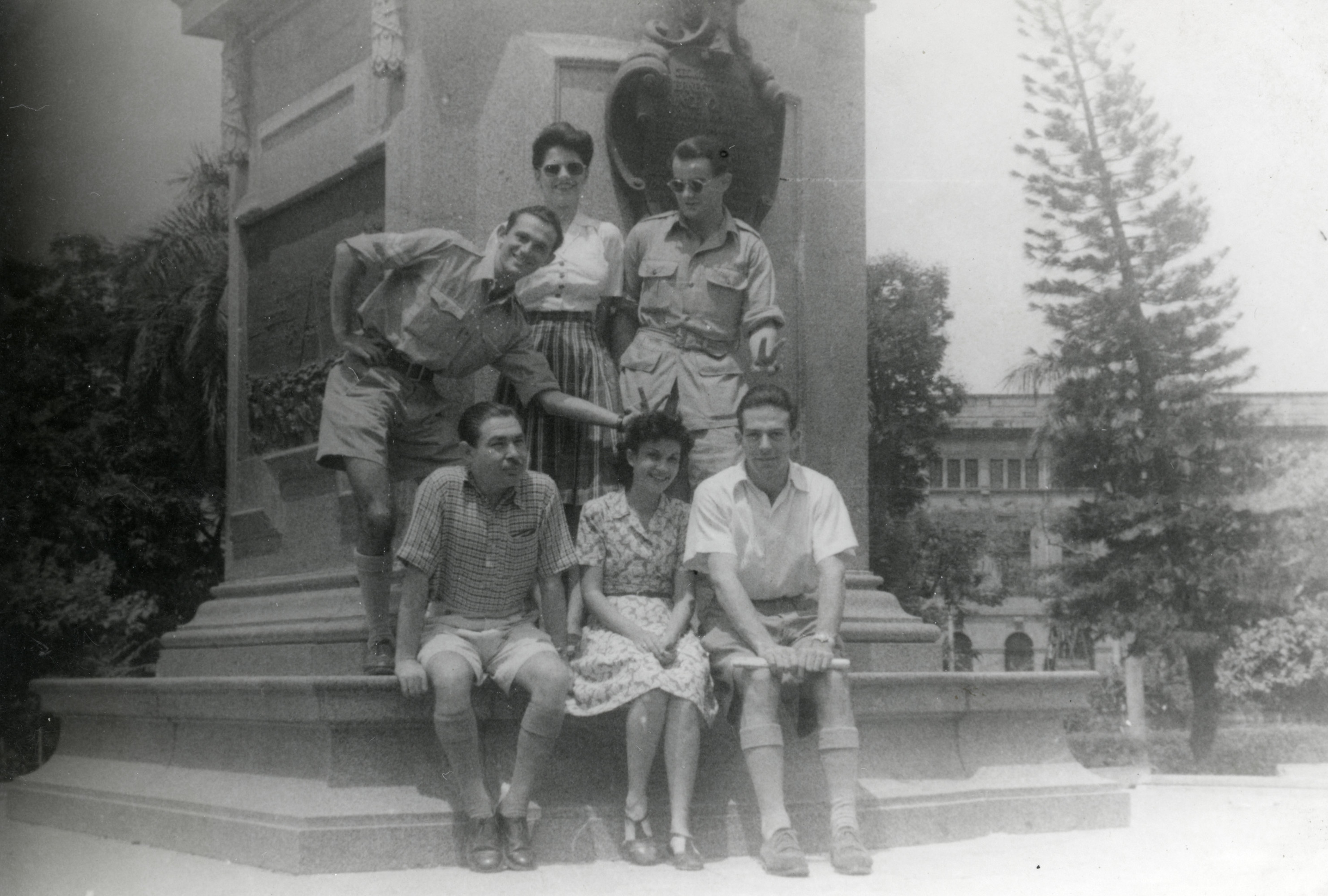 A group of friends pose in front of a monument in the garden of  the Prince of Wales Museum in Bombay, on V-E Day.

Among those pictured is George Klimt (seated in front, far right).