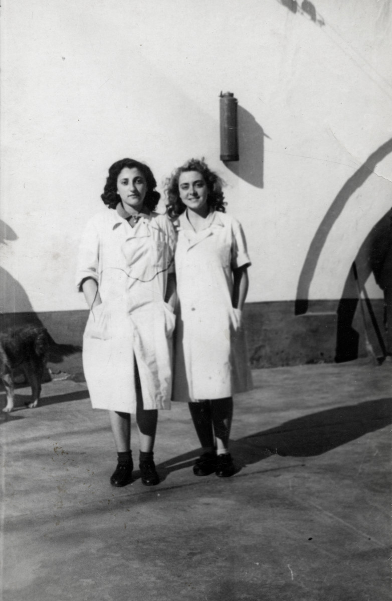 Two Jewish girls stand in the courtyard of the jail in Bucharest. 

Thea Friedman (left) is pictured with Felicia Schwartz (right).
