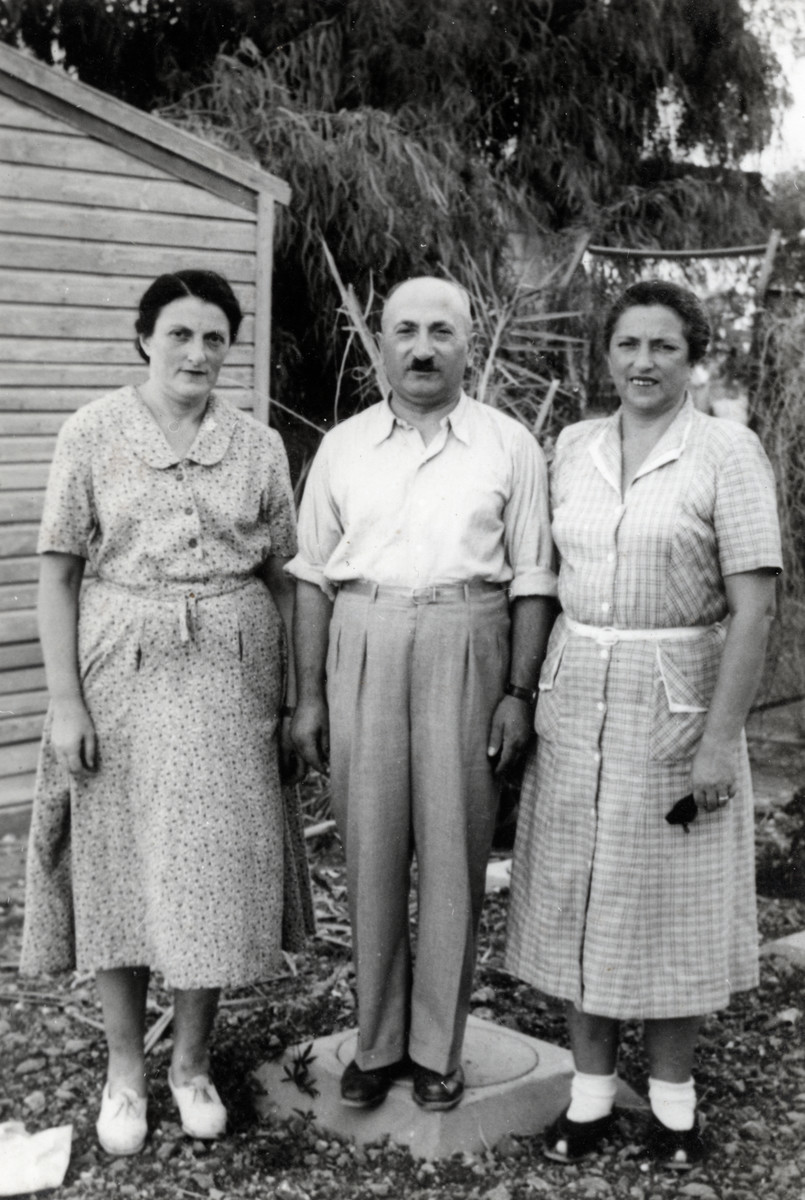 Josef and Yetti Kollenberg (right) stand outside a house next to Yetti's sister, Dora.