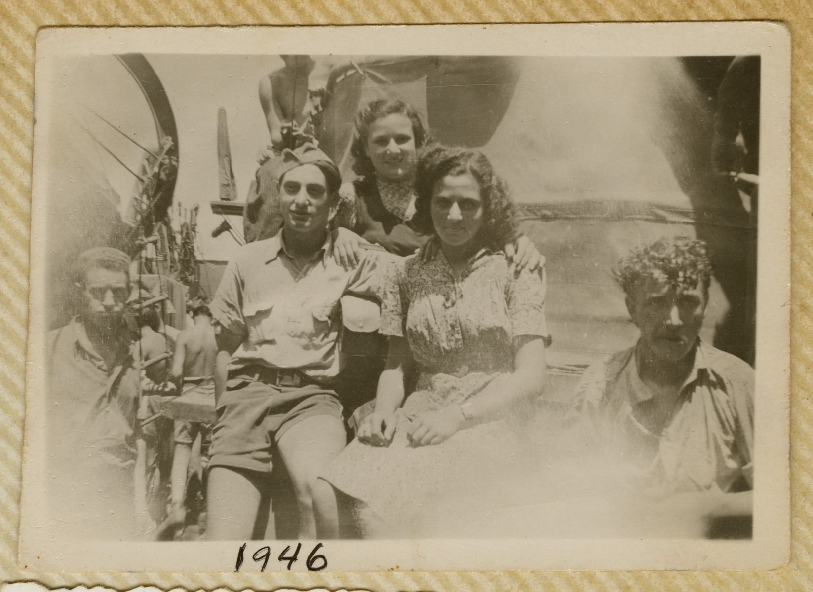 Jewish refugees pose on the deck of the Biriah while en route to Palestine.  

Pictured in the center are Robert, Miriam Ofer and Alitza.