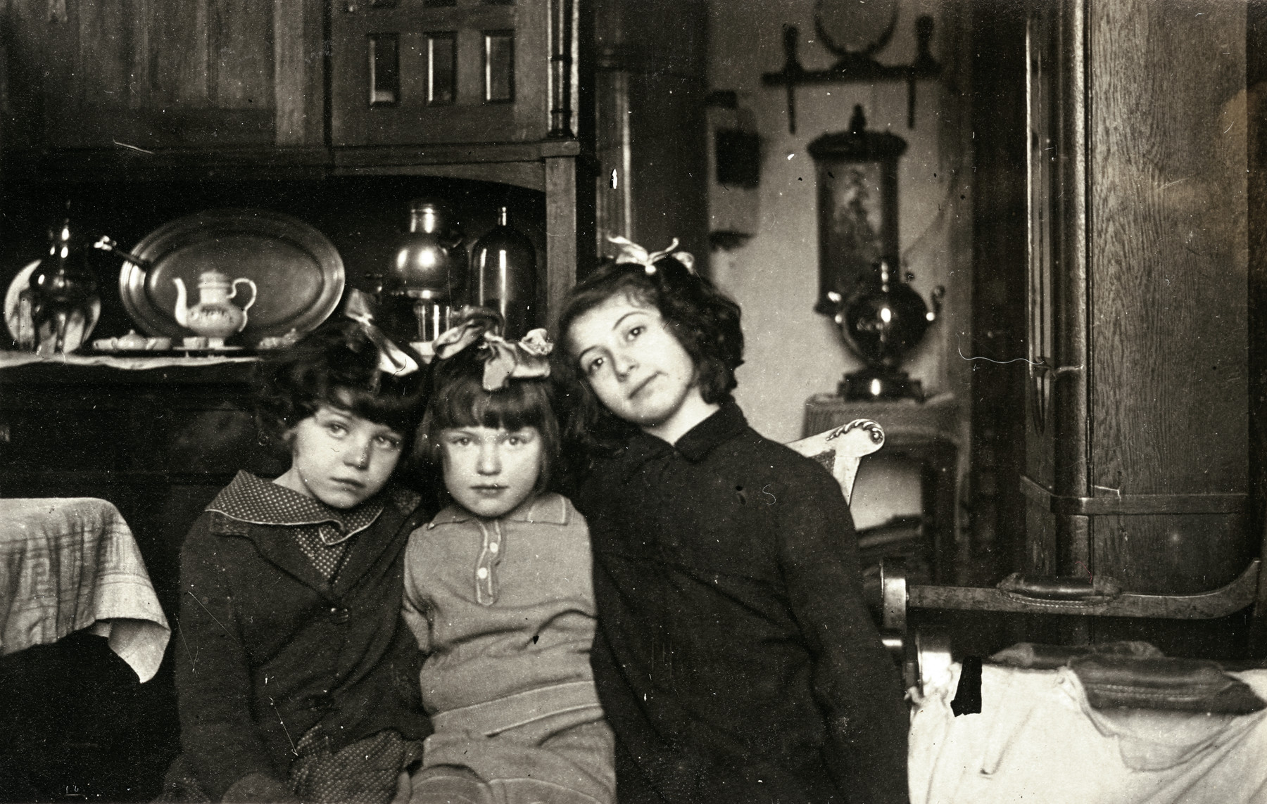 Portrait of three young girls iinside their home.

On the right is Tamara Magid, her cousin Gala Seltzer in the middle and a neighbor on the left.