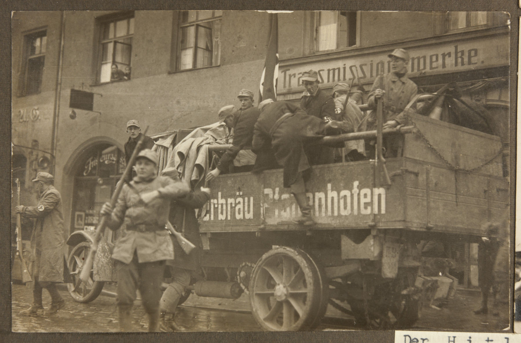 Armed SA men pile out of a truck in to a Munich street during the Beer Hall Putsch.