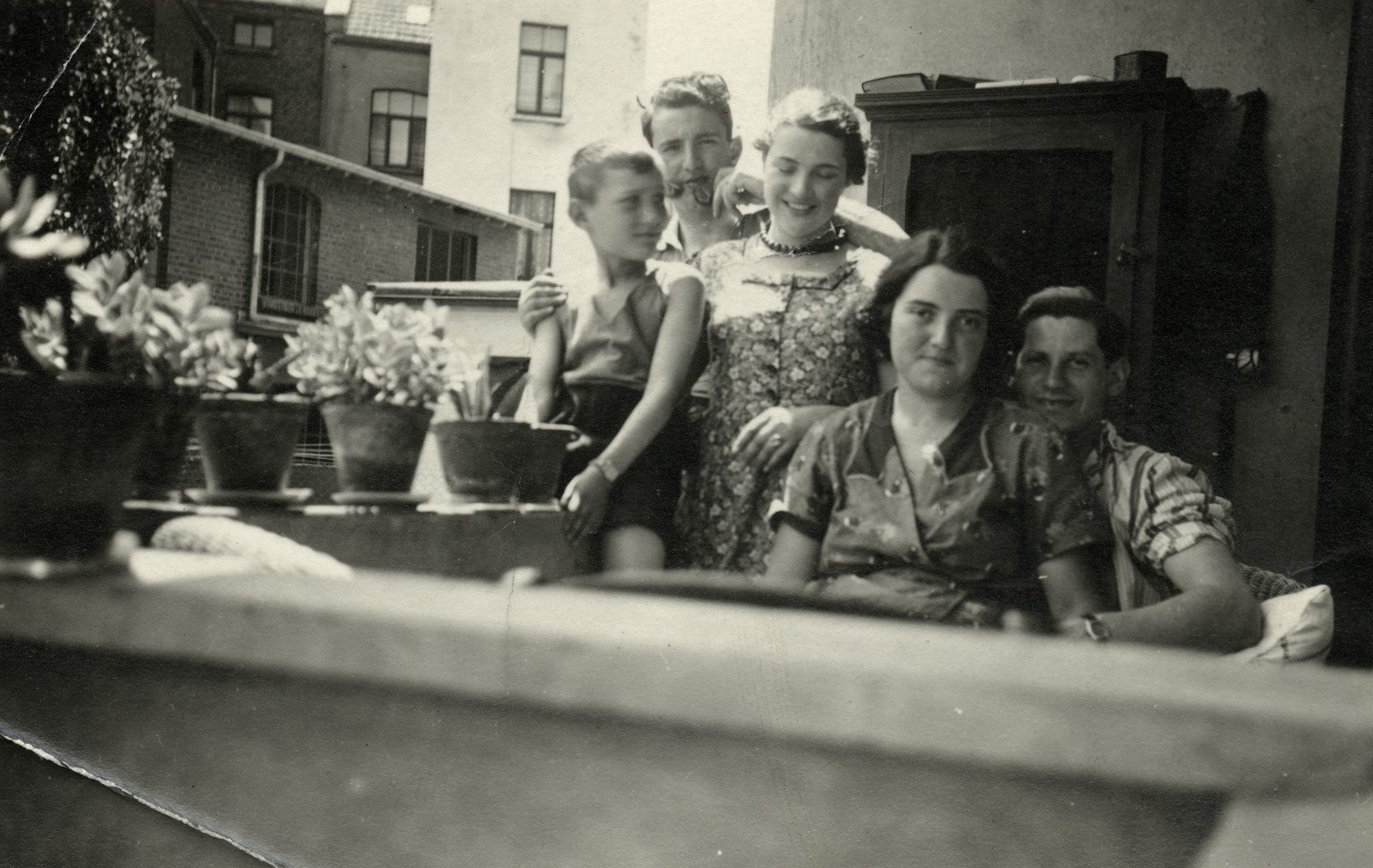 The Meyer children pose on the balcony of their home.

On the far left is Guss Meyer with his sister Erika and brother Herbert. On the right is Gus'older sister Theresa and her husband Carl.