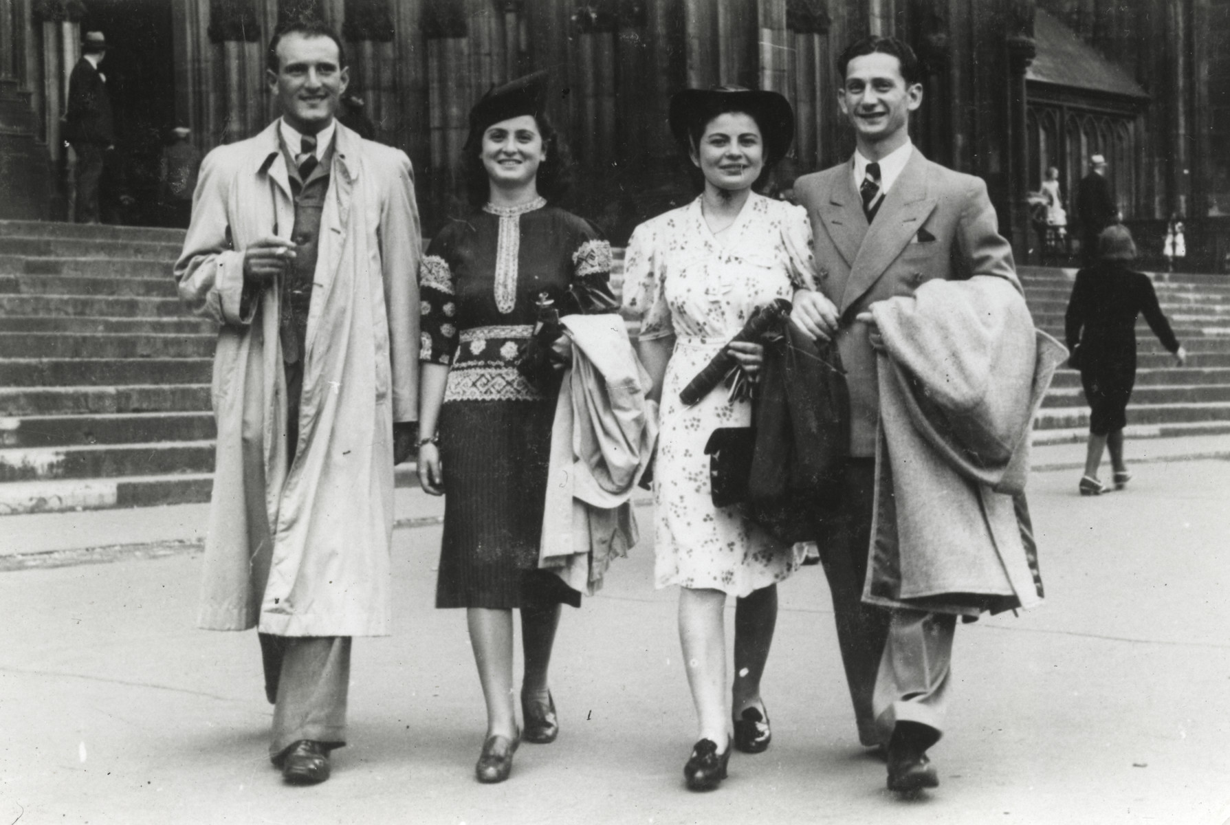 Two Jewish couples walk down a street in Bonn, Germany.

On the left are Herbert and Ruth Meyer who were later deported to Auschwitz.