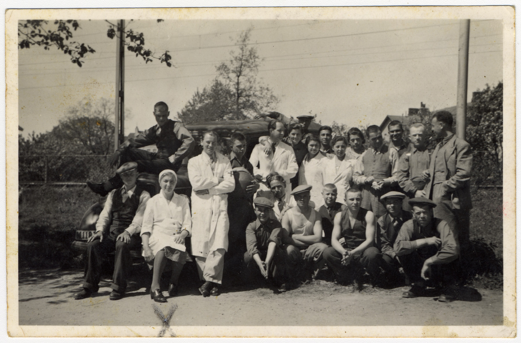 Group portrait of medical personnel and unidentified men in Sweden. 

Among those pictured is Edith Scherzer, sitting second from the left in the first row.