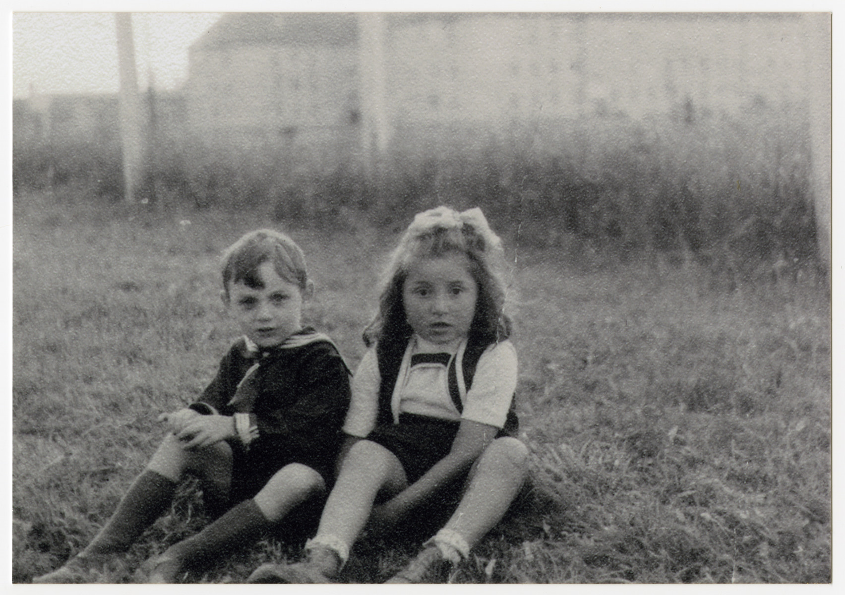 Close-up portrait of two Jewish children [probably in the Steyr] displaced persons camp in Austria.

Pictured on the left is probably Hershel Raysman.