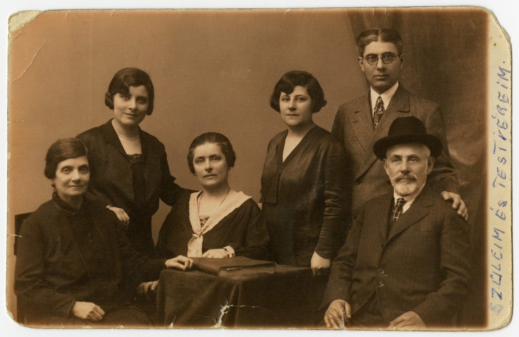 Studio portrait of the Kronovitz family.

Margit Kronovitz (the grandmaother of the donor) is third from the right. Her brother Lutzi who is next to her.  He immigrated to the United States. in  1929. Her parents and sisters perished in the Holocaust