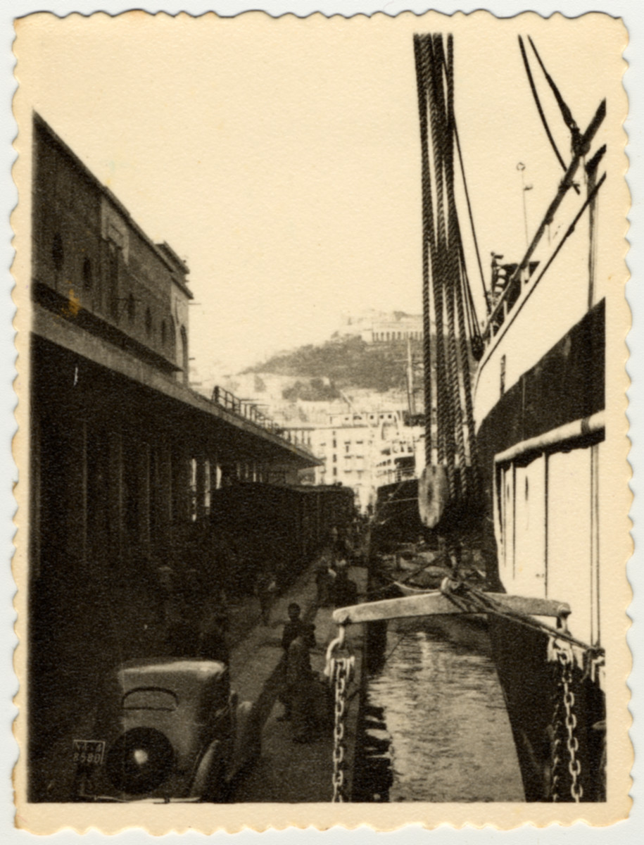 Passengers arrive by train to the port of Naples where they will board the S.S. Caserta.