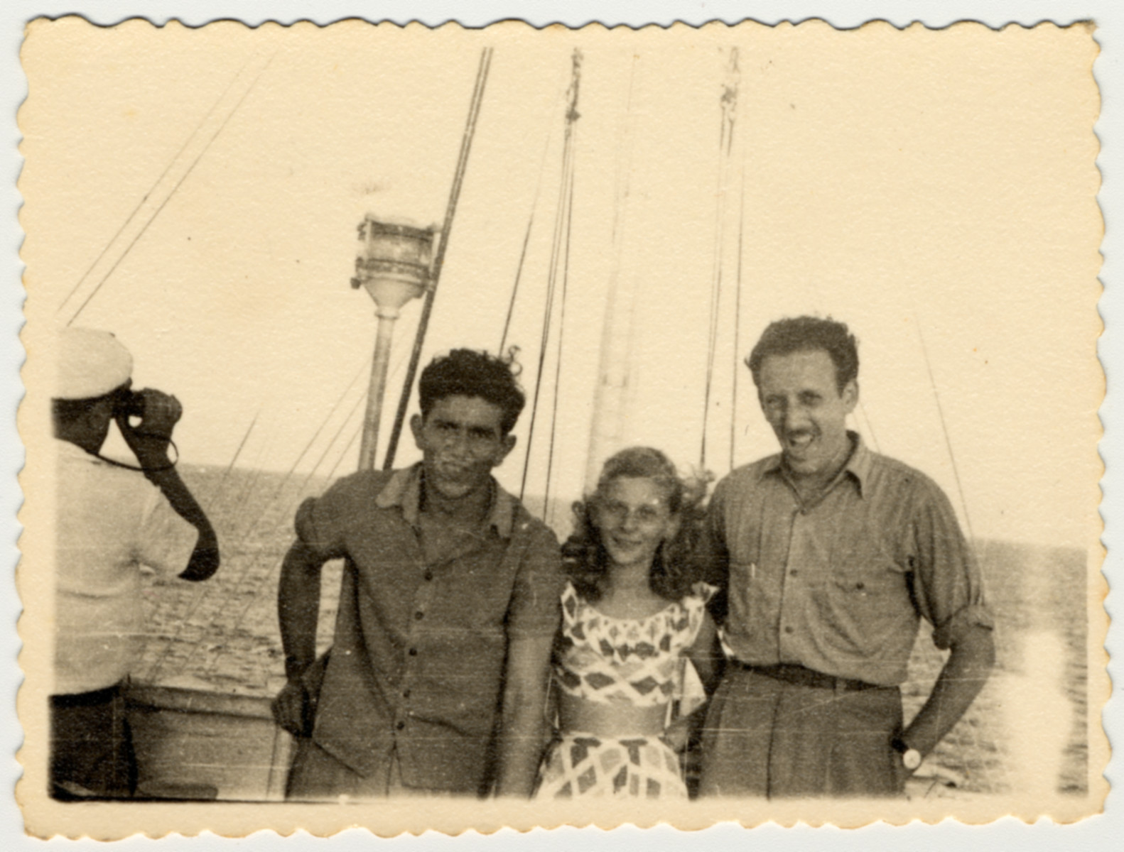 Two teenagers pose with crew member Teddy Vardi on the bridge of the SS Caserta.

Teddy Vardi had helped liberate Nordhausen as a soldier in the U.S. Army before joining the crew of the Exodus and later the Pan Crescent.