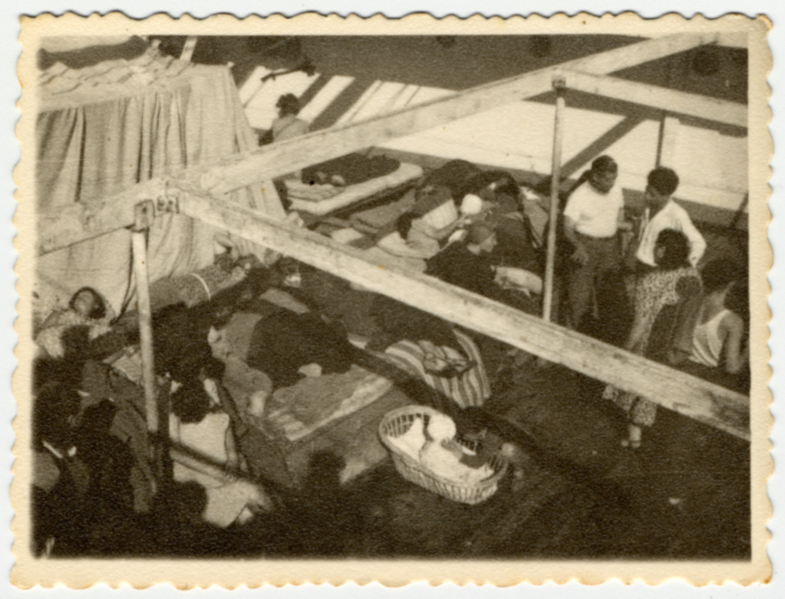 Jewish immigrants evacuating Cyprus for Israel rest on a deck of [what is probably The Atzmaut, Pan Crescent].