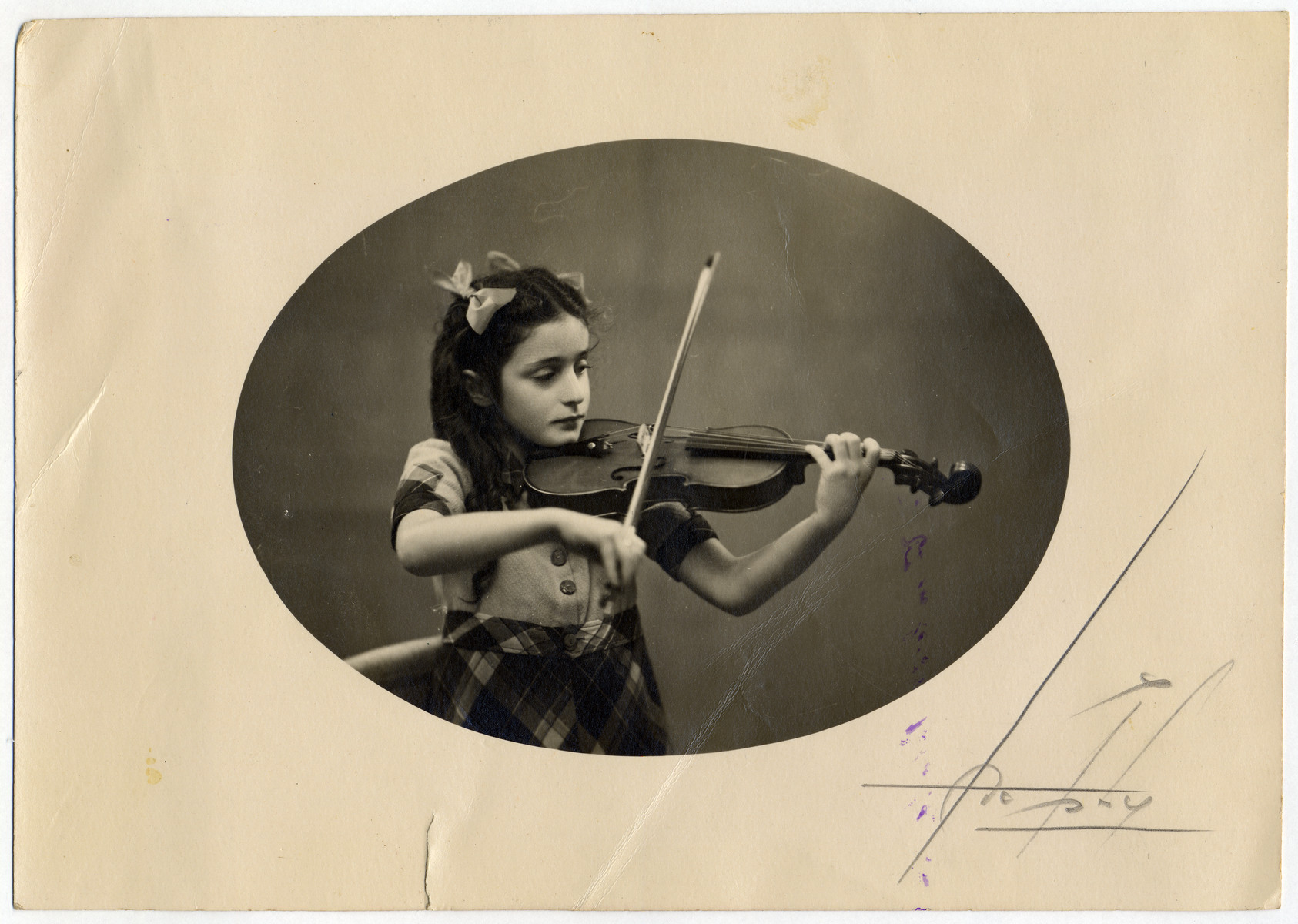 Studio portrait of Annette Gimelstein Tazartes (cousin of the donors) playing the violin.