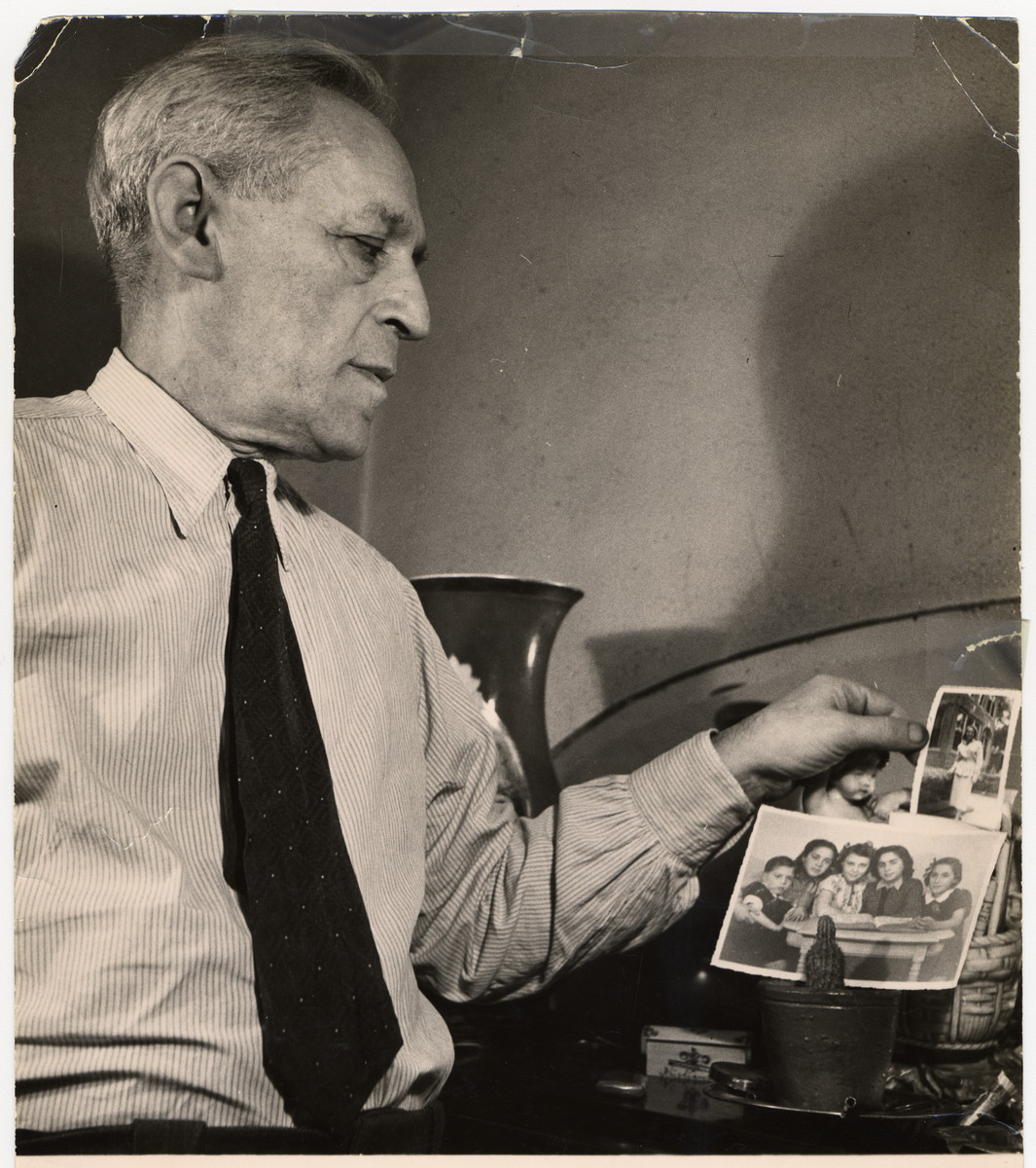 A French Jewsh survivor Albert Abramowitch studies photographs of his relatives.

Albert Abramowitch was the older brother of Roche Leja Gimelstein.  He switched his name to escape the Russian army and kept his pseudonym throughout his life.