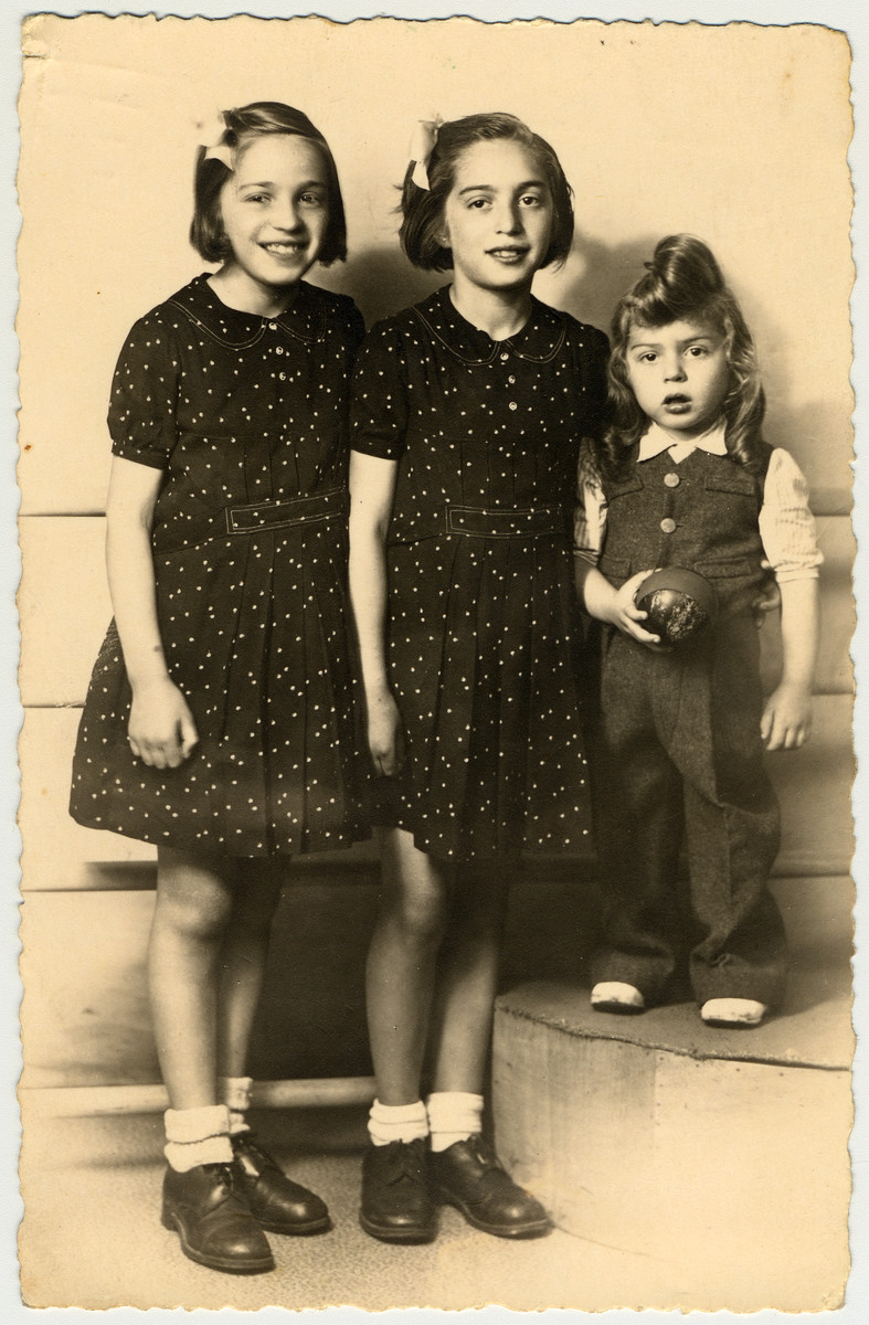 Studio portrait of three French-Jewish siblings taken before they went into hiding.

Pictured are Paulette, Dora and Michel Feiler.