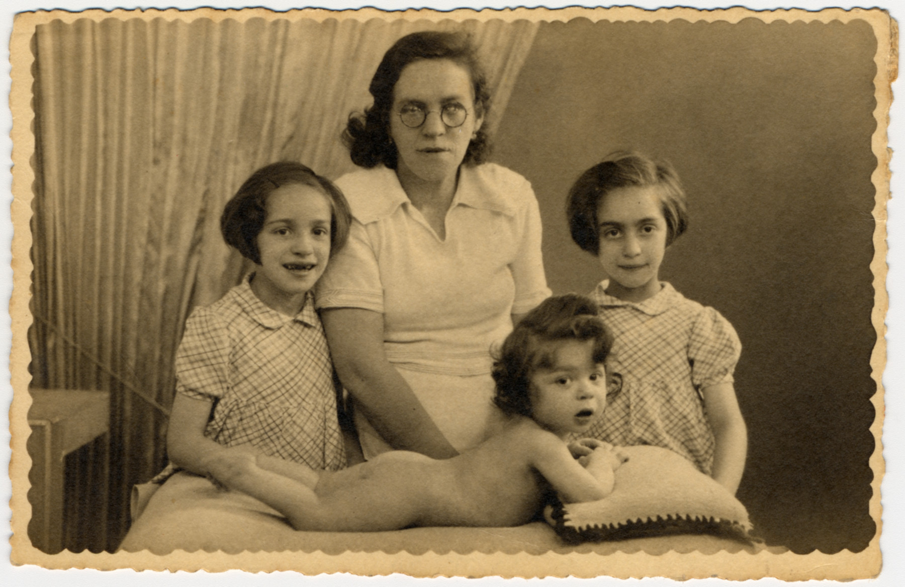 A Jewish mother, Roche Leja Feiler, poses with her three young children in Paris, France.

Pictured are Dora Feiler (left), Roche Leja Gimelstein Feiler, Michel Feiler and Paulette Feiler.