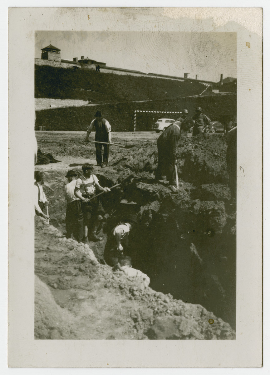 American troops oversee Germans digging a pit at Ohrdruf, a satellite camp of Buchenwald, following liberation.