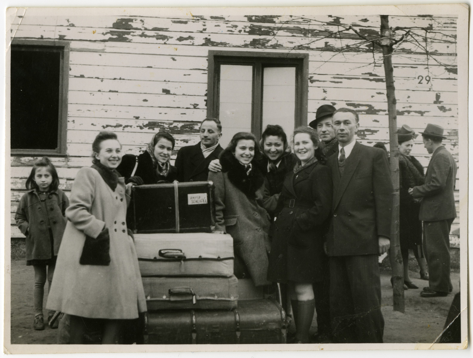 Residents of the Schlachtensee displaced persons' camp bid farewell to the Rothbaums who are leaving for America.

Pictured are Lusia, Genia and Chajka Rothbaum as well as Laura Kimmel (fourth from right) and Alfred Kimmel (second from right).