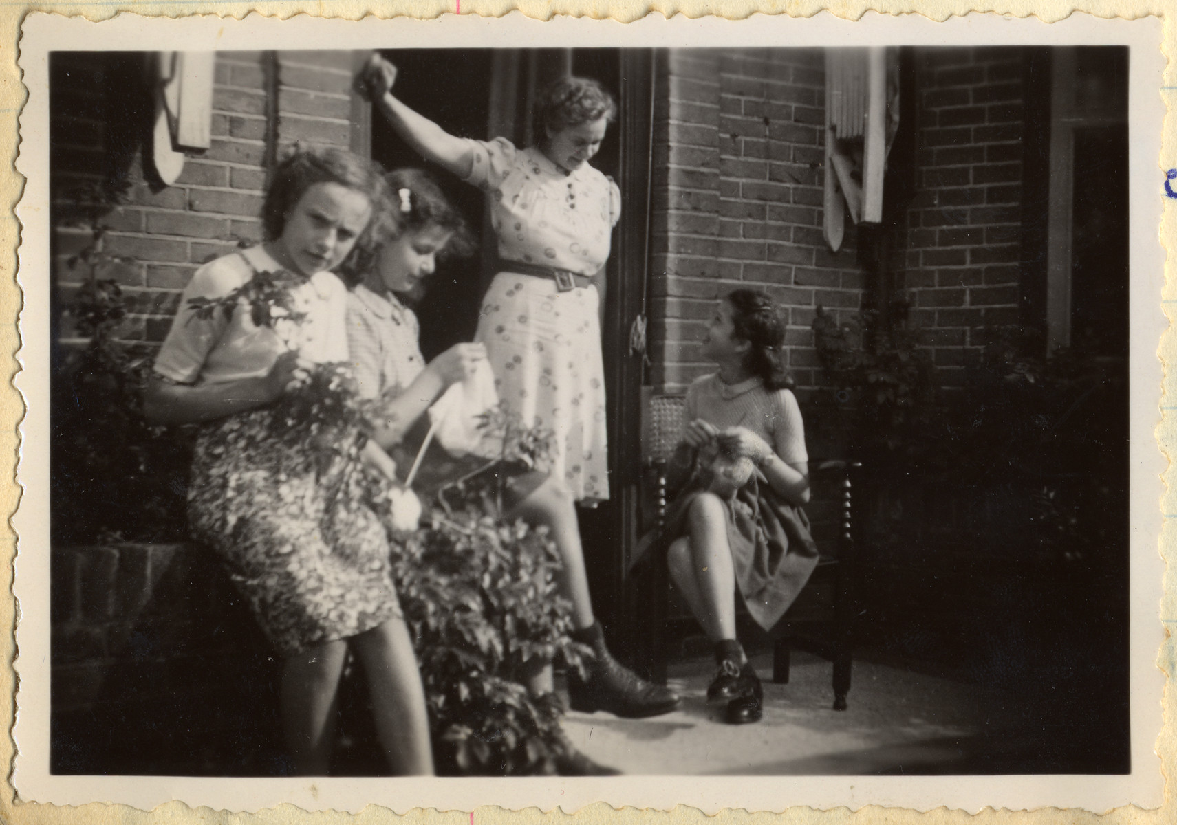 Jacqueline (second from left) and Manuela Mendels (far right) knit outside their uncle's home in Hilversum.