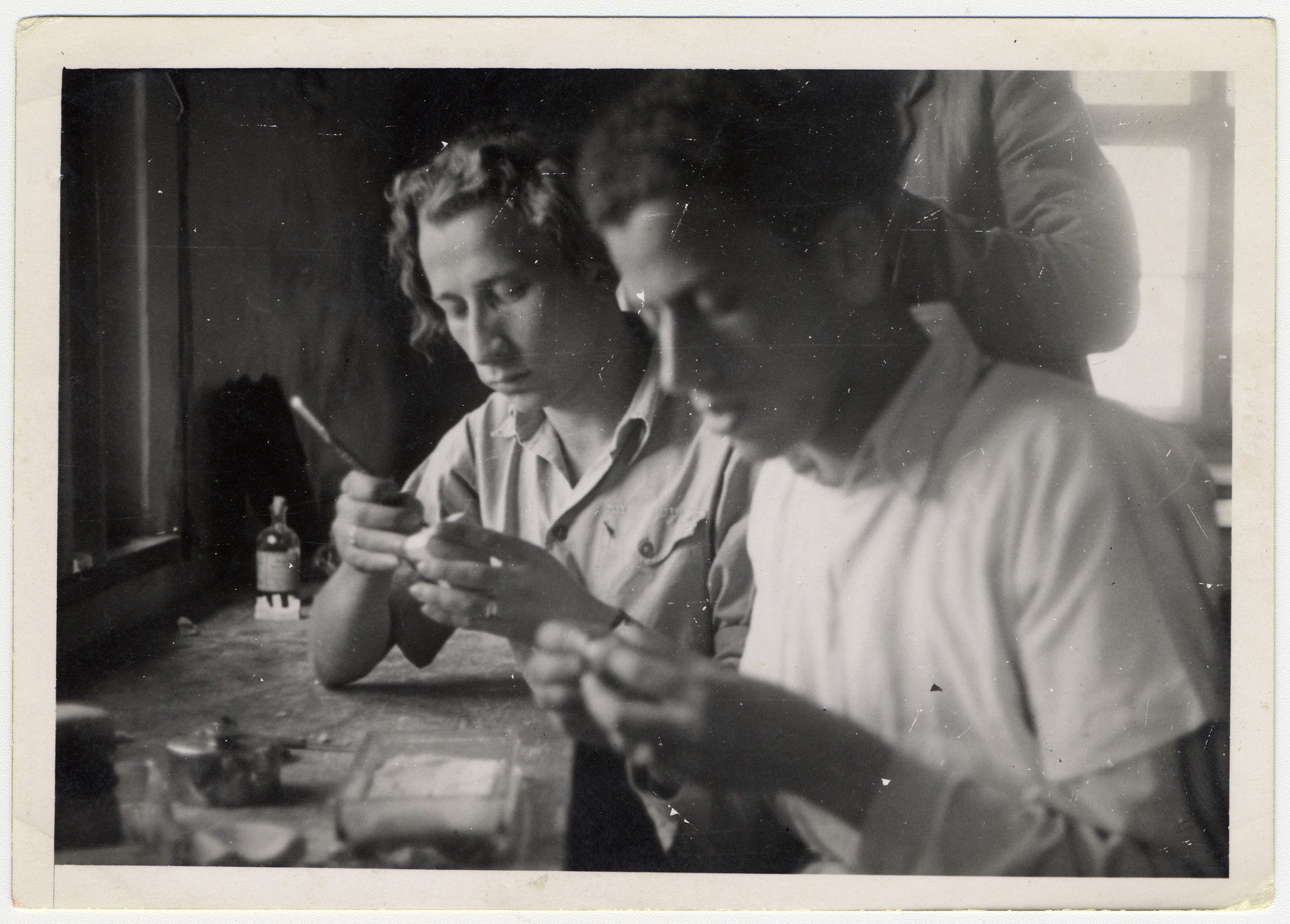Two young men practice dentistry in the ORT dental technicians school in the Bergen-Belsen displaced persons camp.