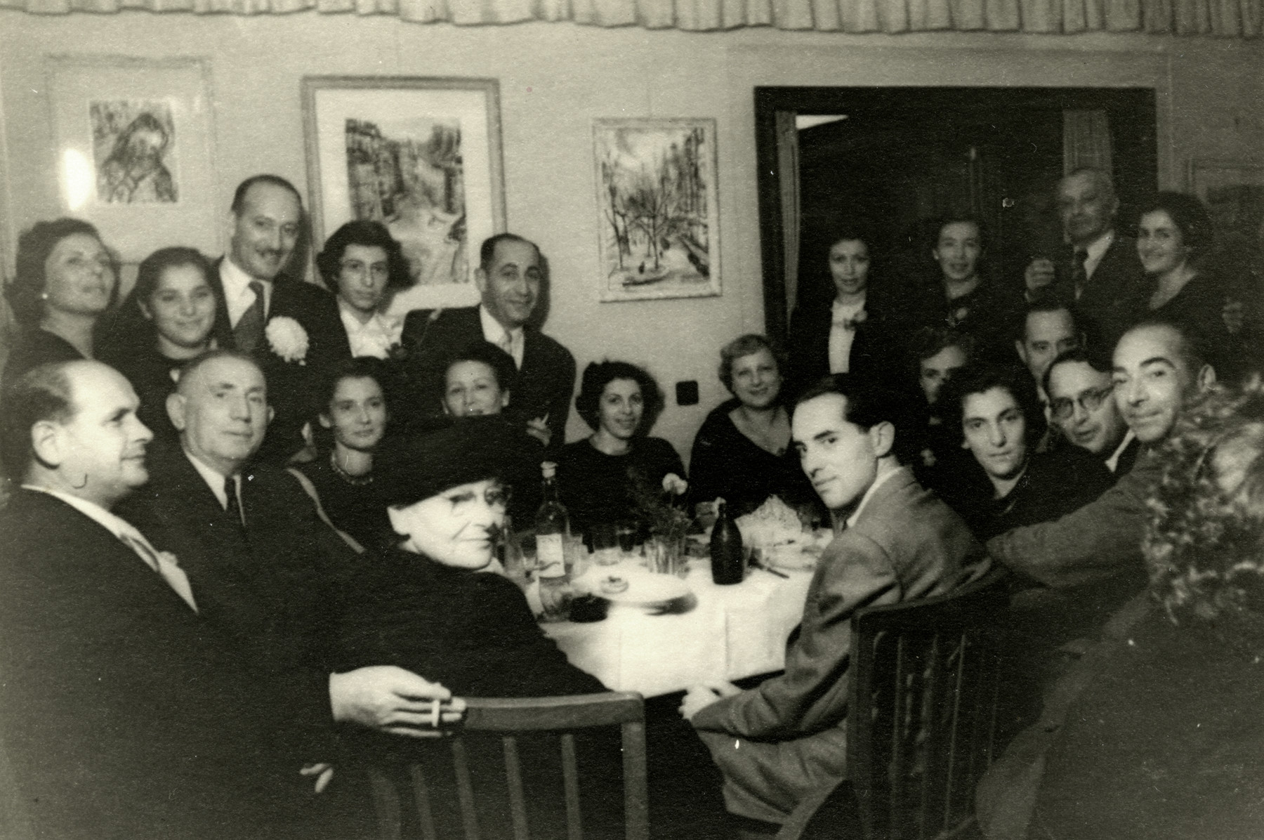 Former patisans gather for a party  in Tel Aviv after the war.

David Svirsky is seated in front at the table wearing a suit.