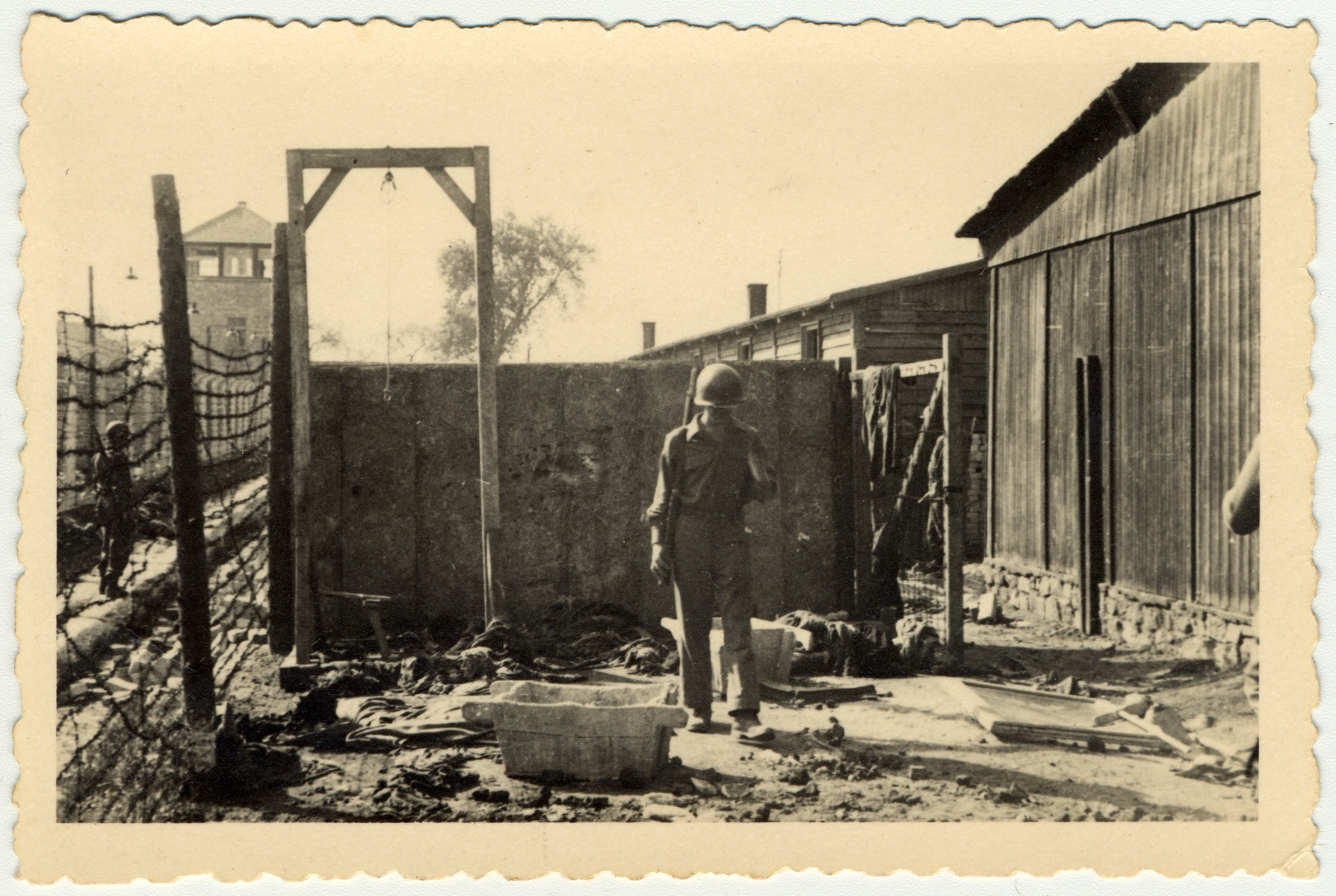 An American soldier inspects the gallows of the Mauthausen concentration camp.

The original caption reads: "This is one place they shot and hung the people."