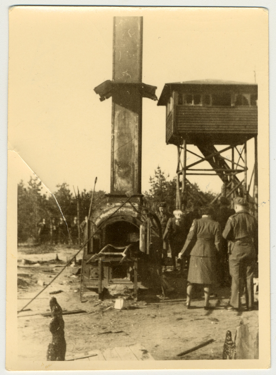 British soldiers walk past a cremation oven after the destruction and liberation of Bergen-Belsen.
