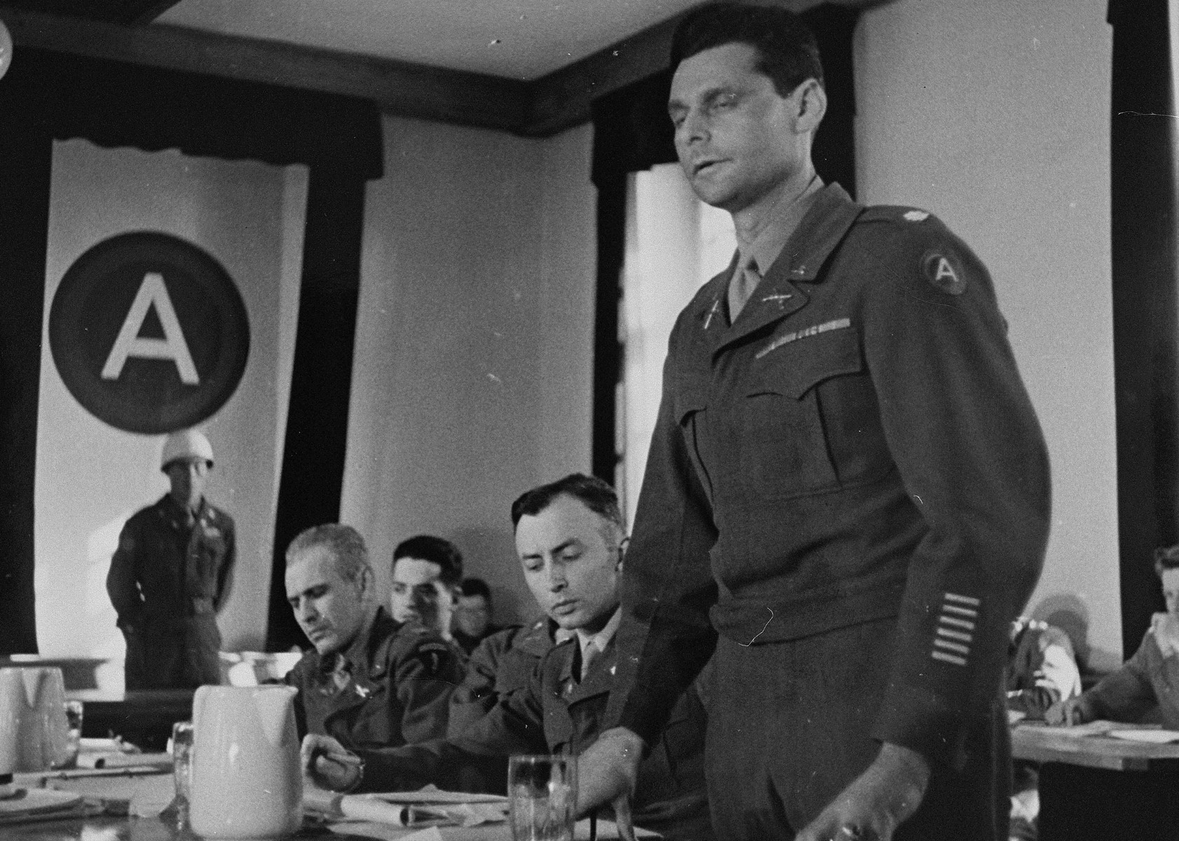 The American prosecution team at the trial of 61 former camp personnel and prisoners from Mauthausen.  

Among those pictured is William Denson (seated in the middle next to the lawyer who is standing).