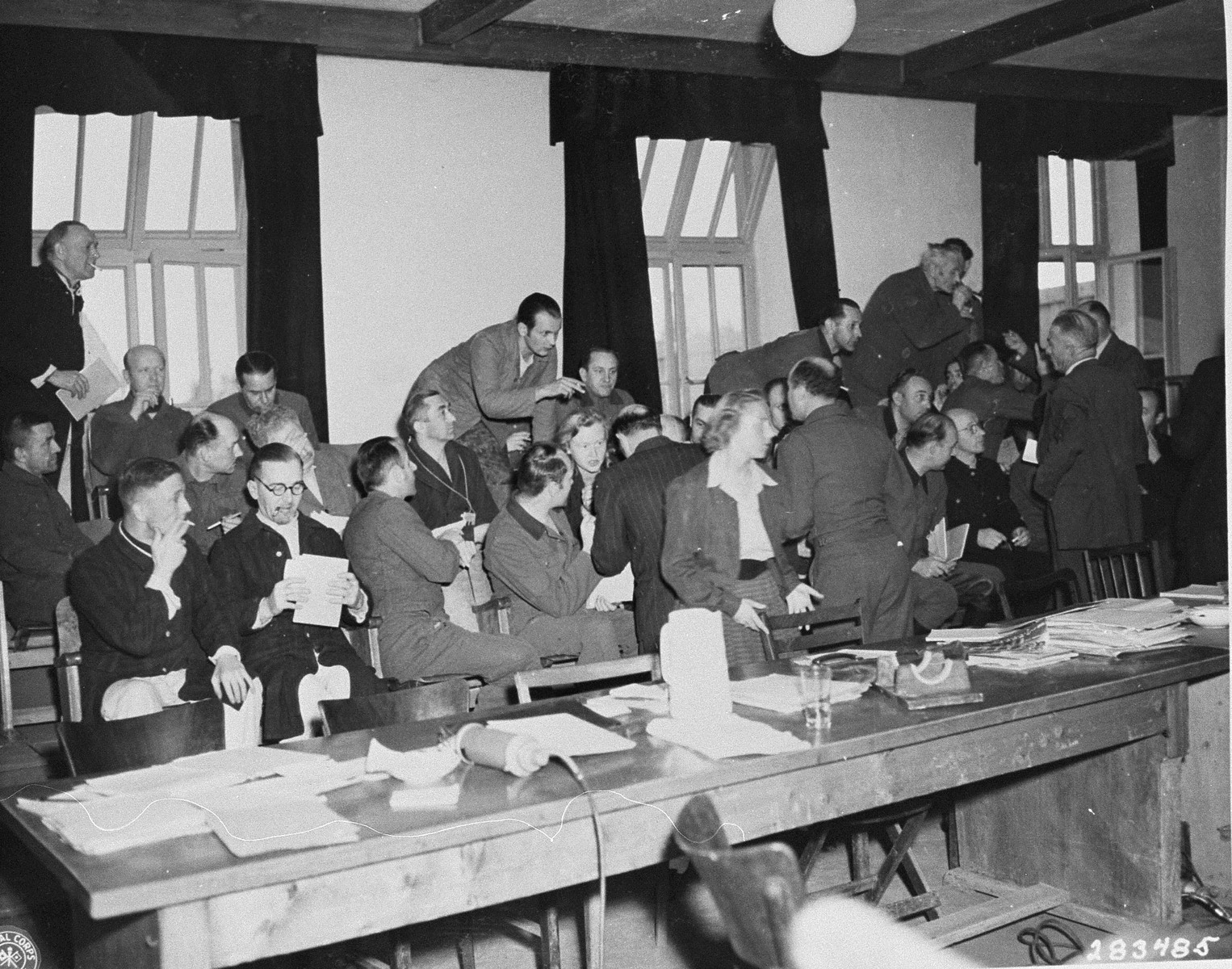 Defendants confer with their defending counselors at the trial of former camp personnel and prisoners from Buchenwald.