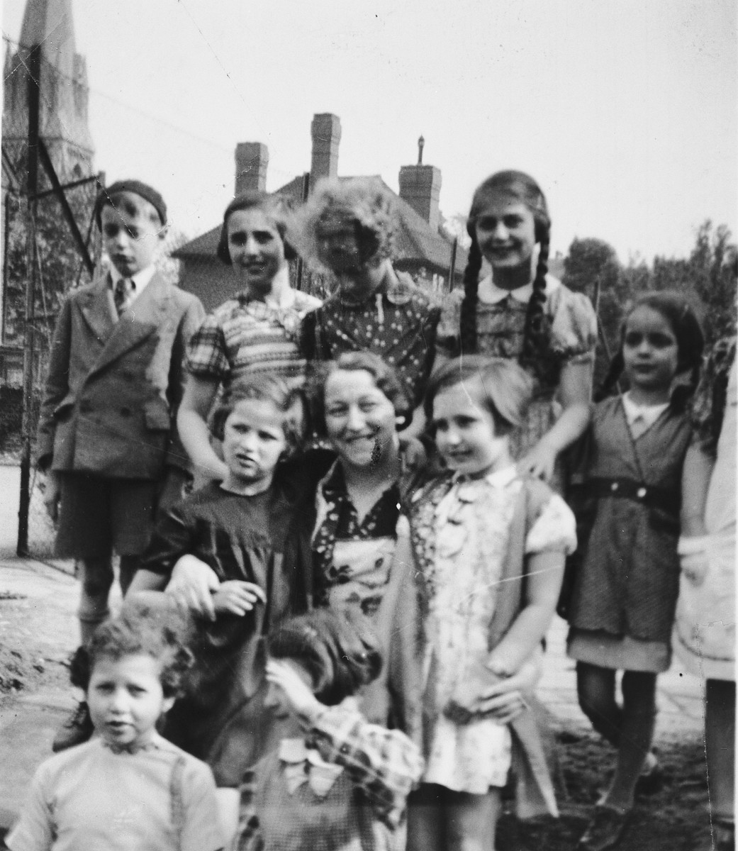 Group portrait of girls in from the 5th Avenue Hostel who came to England on a Kindertransport.

Henni Zajac is pictured standing on the left in the second row.  Pictured on the top row left is possibly Fred Gottlieb and on the top row right is possibly his sister, Miriam Gottlieb.