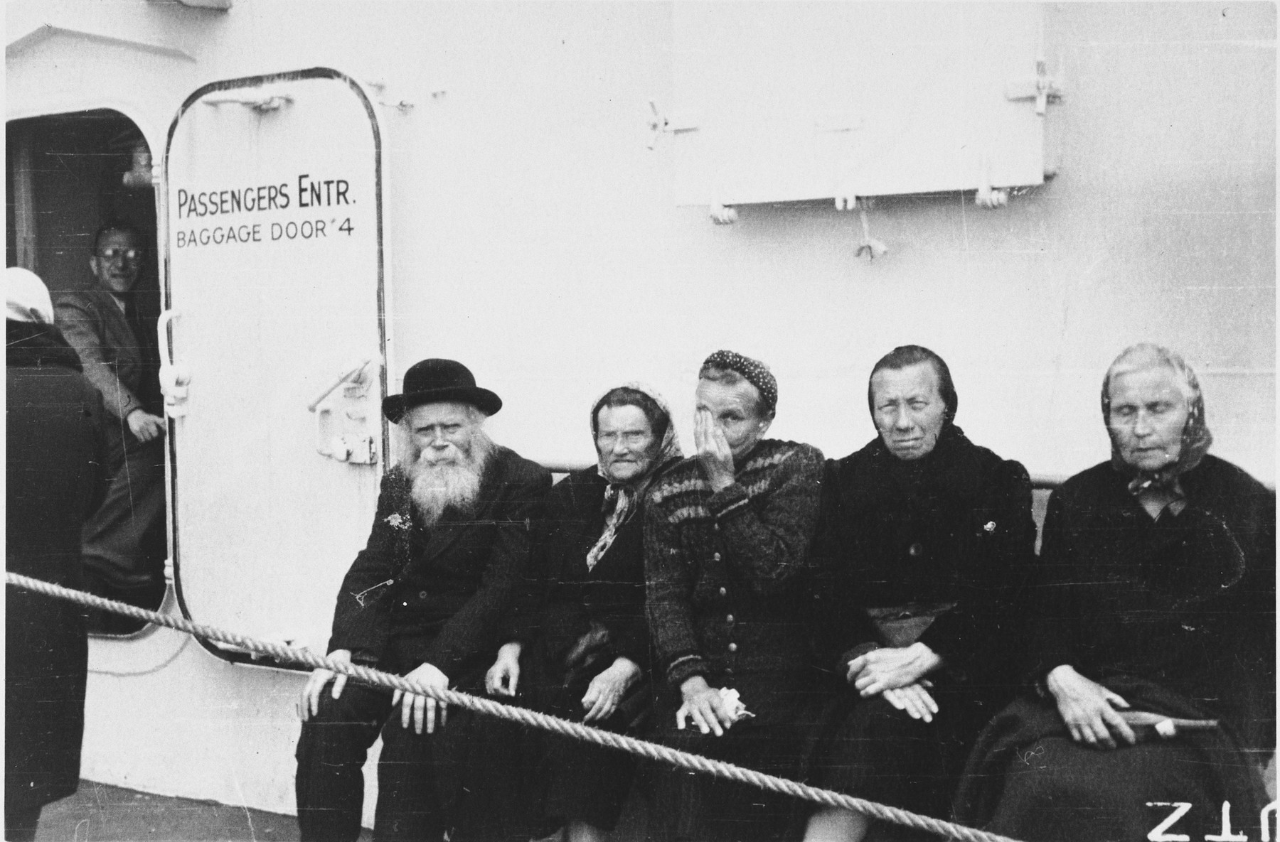 Elderly Jews sit on the deck of the SS Marine Marlin while en route to the United States.

Among those pictured (seated on the far left) are Shlomo Chaim and Brandel (nee Hoffert) Nussbaum, from Kolbuszowa, Poland. They survived the war as prisoners in a gulag in Siberia, with their daughter.