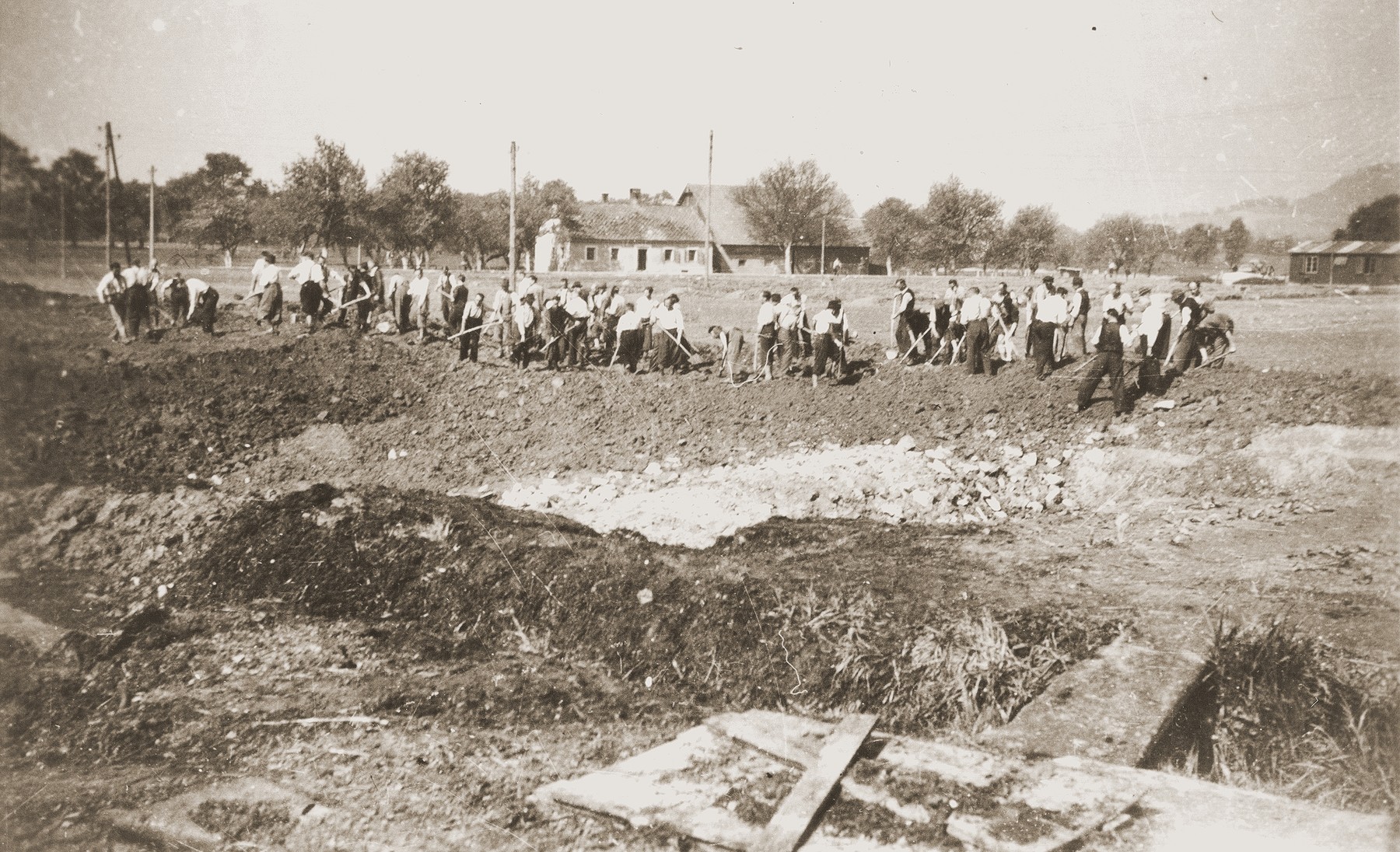 Austrian civilians prepare a mass grave to bury the bodies of former inmates at the Mauthausen concentration camp.

The donor's caption reads, "(Lager) Camp Gusen, Austria.  Civilians were told to wear their best clothes to the graveyards!  So as to go home with stench of death to be cleaned off!!  May 1945."
