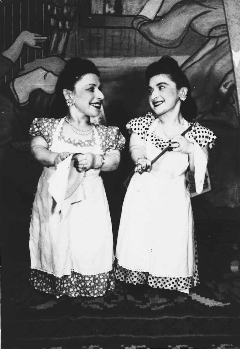 Two members of the Ovici family, a family of Jewish dwarf entertainers who survived Auschwitz, perform on stage.

Pictured are Perla and Elizabeth Ovici.