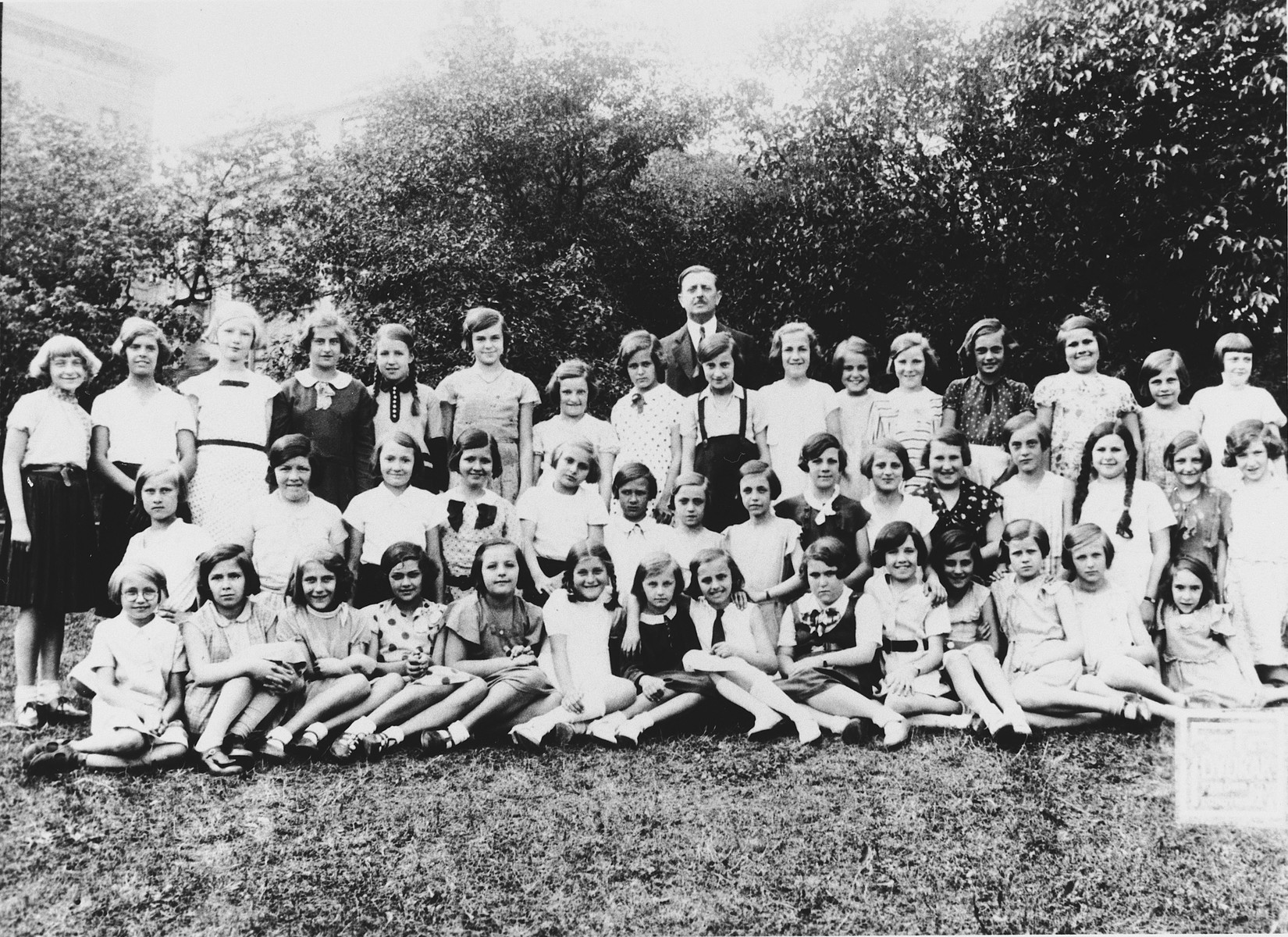 Group portrait of children from a public grammer school in Prague on an outing.  Some of the girls are Jewish.

Among those pictured is Hana Fuchs.