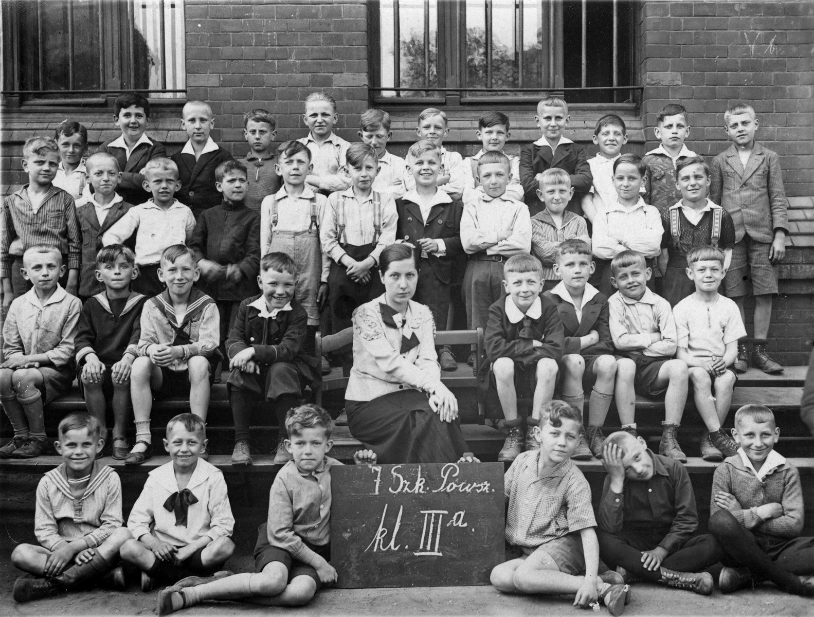Group portrait of students in the third class of a Polish elementary school in Poznan.

Among those pictured is a Jewish child, Zygmunt Bauman (top row, left) who is the donor's father.
