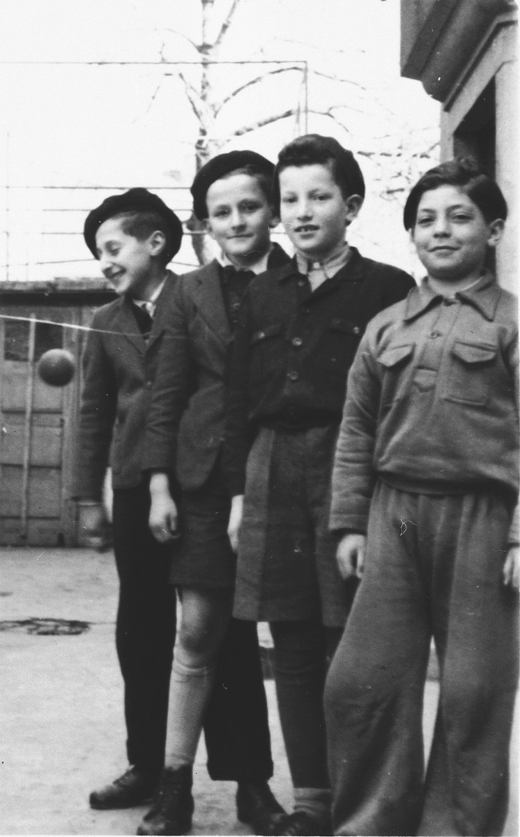 Portrait of four boys standing outside in the Stuttgart displaced persons' camp.

Those pictured include Miron Bander (third from left) and Tom Ferbel (far right).