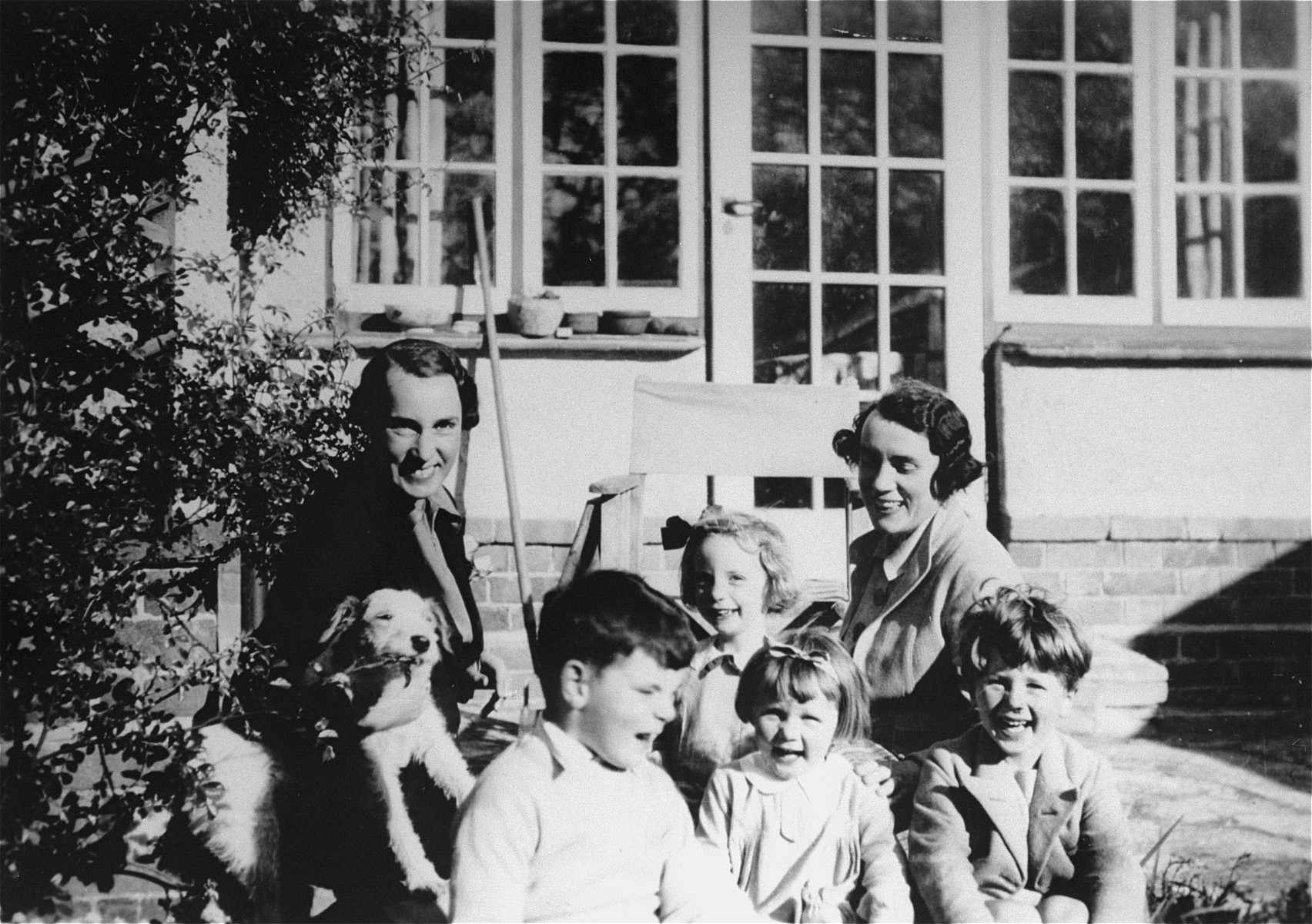 Two British Quaker women who served as foster parents to Jewish Kindertransport children, pose with a group of young children in Bristol.

Mary Moar is pictured on left; her sister Mrs. Baker, on the right.