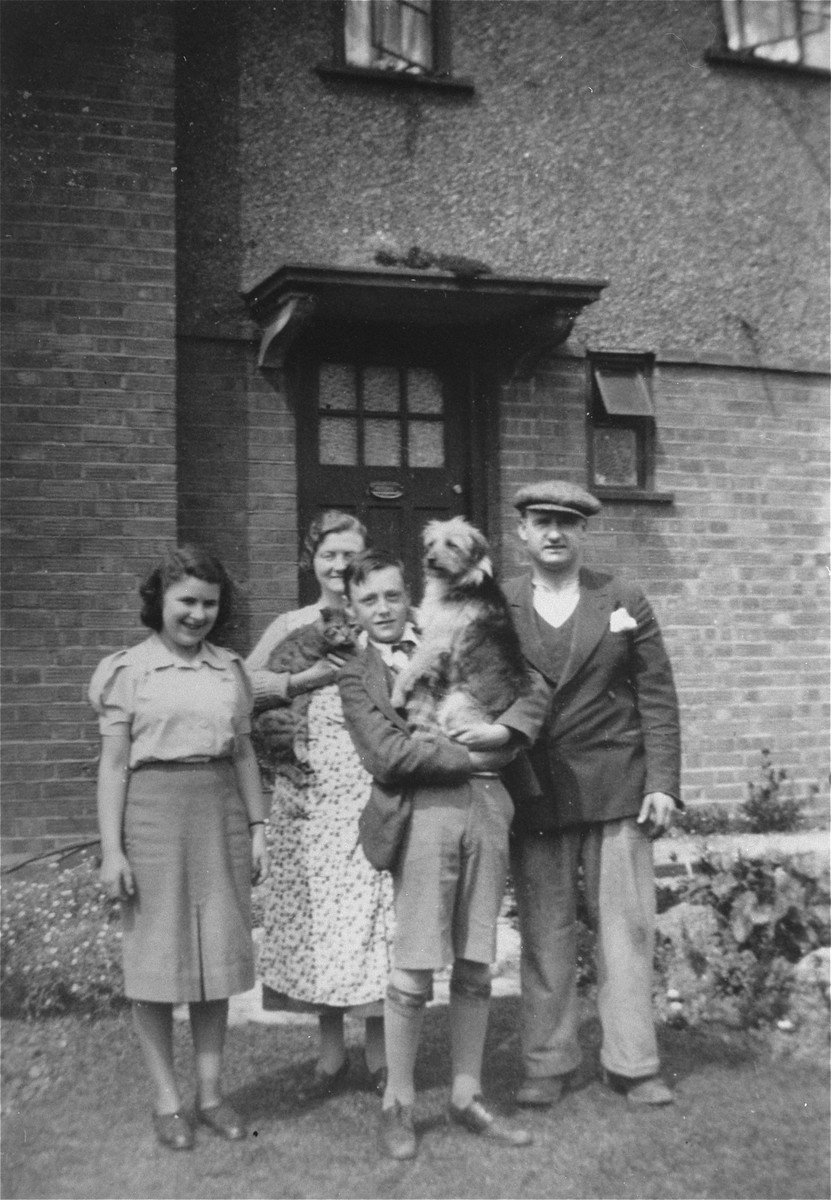 Berta Rosenhein (now Berta Hertz) with the Sampson family. 

Berta was assigned to live with the Sampsons at Bloomsbury House from March 1939-1942. From left  to right:  Berta, Mrs. Sampson (Kathleen), the Sampson's son and dog, and Mr. Sampson (Harry). Mr. Sampson was a housepainter, and joined the RAF when the war started.