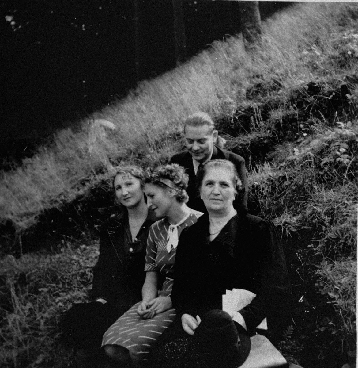 Dr. Joseph Jaksy poses on a hillside in Bratislava with members of the Suran family, whom he rescued during WWII. 

Pictured with Dr. Jaksy from left to right are Valeria, Lydia and Mrs. Suran.

The Surans were among the 25 Jews rescued by Dr. Joseph Jaksy during WWII.  Jaksy engineered the fictitious purchase of the Suran's home in Bratislava; he provided false papers that allowed the Suran children to escape to South America; he registered the elder Surans as his own Slovak domestics; and, after a Gestapo search of the house, he provided Mrs. Suran with false papers and drove her to safety.
