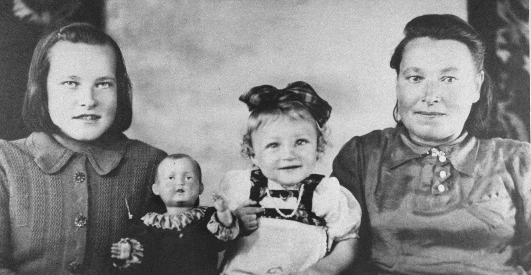 A Jewish child in hiding poses with members of the Lithuanian family that concealed her.  Pictured is the donor, Josephina Martul (right), and her daughter, Leonarda-Luisa (left) 

Rose Levin (now Weinberg) is the daughter of Ida and Yossef Levin.  She was born in  March 1941 in Vilna.  Her older sister, Chaya, was born in 1936.  Her father was shot by the Germans shortly after the beginning of the German occupation.  Rose's mother then placed her with a Lithuanian family named Martul.  Rose passed as a relative whose name was Vera Martul.  After the death of her foster mother, Josephina Martul, Rose was cared for by the sixteen year-old daughter of the family, Lusia  Martul-Budrikiene.  Rose remained with Lusia Budrikene until 1957, when an aunt from Canada, Mrs. Friedman,  located her and arranged for her emigration to Toronto.  In 1993, Yad Vashem recognized Josephine Martul and her daughter Lusia Budrikiene as Righteous Among the Nations.